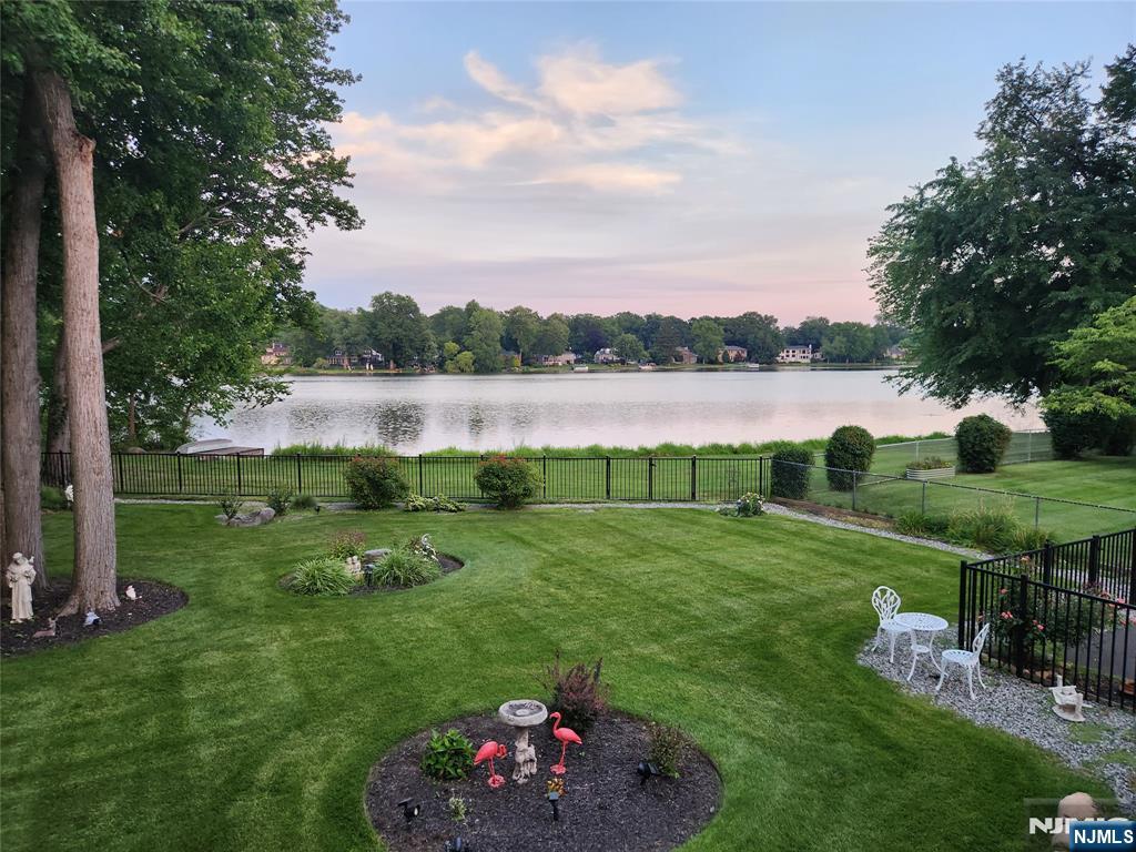 Rarely does a home with such spectacular, unobstructed lake views become available. Perfectly positioned along beautiful Schlegel Lake, this expanded 3-4 BR, 3 new bath Colonial offers a setting that is truly unforgettable. Set on approximately 1/3 acre of professionally landscaped property, it's a place where every season can be enjoyed from the comfort of your own wrap-around deck. Expansive picture windows throughout the Formal Living Room with fireplace, Formal Dining Room, Primary Suite and more showcase the breathtaking views. A first-floor Den offers flexibility as a Home Office or Guest Bedroom. The spacious Primary Suite features a gorgeous new bath with radiant heated floors. Additional highlights include concrete block construction with vinyl siding, crown moldings, a 2-year-old roof, 2-zone gas heat, approximately 5-year-old gas furnace and central air, split-system A/C, whole-house generator, u/g sprinklers, fenced yard, paver walkways, storage shed, attached 1-car garage with electric opener and a driveway for 6 cars and a basement. Be sure to view the photos and video tour to fully appreciate this one-of-a-kind home and its extraordinary setting Quiet street. Close to the library, shopping, schools, houses of worship and direct access to Schlegel Lake. Be sure to view the photos and video tour to fully appreciate this one-of-a-kind home and its extraordinary setting