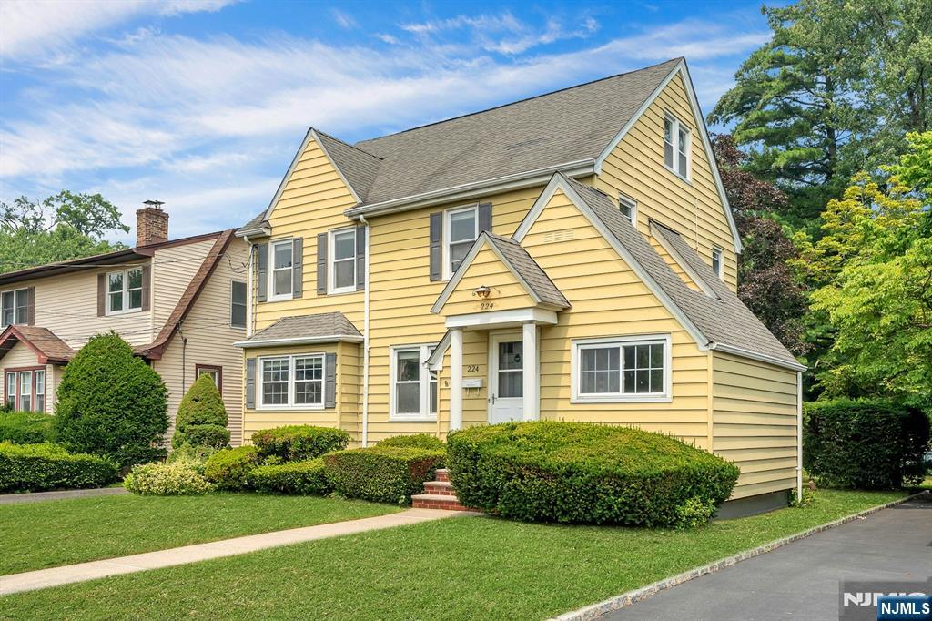 Elegant and spacious Tudor Colonial located in the heart of Hackensack's sought after Fairmount neighborhood! This beautiful home has been meticulously maintained with pride of ownership evident throughout. Enter through the original french door from the foyer into an impressive oversized formal living room, flooded with natural light, featuring a fireplace flanked by built-ins on each side. The spacious formal dining room and bonus den/office are both located immediately off the living room creating a lovely flow for everyday living and entertaining. Kitchen, half bath and charming breakfast nook complete the first floor. The second floor features three ample bedrooms, including two king-sized rooms, and a full bathroom. The walk-up third floor offers tremendous potential with high ceilings and can be easily finished into a luxurious primary suite, fabulous game room, or simply kept as-is offering tons of easily accessible storage. Partially finished basement with second half bath, oversized 150' deep property with two-car garage, hardwood floors throughout. Enjoy the convenience of Hackensack's multiple commuter options, easy access to highways, shopping, local dining and HUMC, while still being tucked away on one of the Fairmount sections loveliest tree-lined streets!