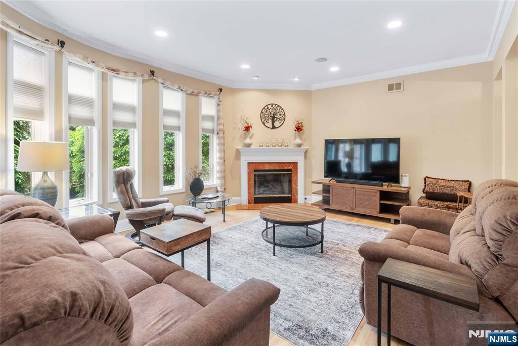 Welcome to refined luxury living in the prestigious Hudson Cove community. This stunning 4-bedroom, 3.5-bath townhome offers approximately 2,198 sq. ft. of beautifully designed space across three expansive levels, blending elegance with everyday comfort. Step inside to soaring ceilings, a grand staircase, and a light-filled, open layout designed for both entertaining and relaxed living. The main level features a spacious living area with a cozy gas fireplace, a formal dining space, and a convenient powder room. At the heart of the home is the chefâ€™s kitchen, complete with stainless steel appliances, a generous center island, and direct access to a large private deck with a gas line, perfect for effortless outdoor gatherings. Upstairs, retreat to the serene primary suite showcasing vaulted ceilings, walk-in closets, private balcony and a spa-inspired bath with a separate glass-enclosed shower and luxurious jacuzzi tub. Two additional bedrooms and a full bath complete this level. The ground floor offers exceptional versatility with a spacious flex room, ideal as a fourth bedroom, family room, or home office alongside a full bath and direct access to a private walkout patio. Enjoy in unit W/D and your private 2 car garage, parking for 4. Hudson Cove is an exclusive gated community, including beautifully landscaped grounds, a pool, jacuzzi, and convenient access to NYC delivering the perfect balance of privacy, convenience, and upscale living.