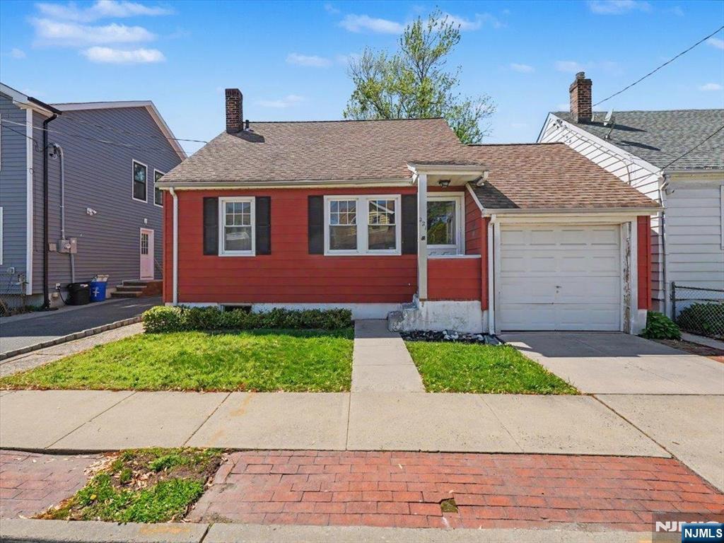 Welcome to this charming single-family home in The Valley neighborhood of Belleville. This classic-style home is perfectly sized for first time homeowners, growing families or downsizers. The main level features a living room, two versatile rooms that can function as bedrooms, living, dining, or play space, along with a spacious eat-in kitchen, a full bath with tub, and original hardwood floors. Upstairs, a finished room beneath the eaves provides an ideal guest room or home office and connects to additional attic storage. The finished basement adds valuable bonus space with a cozy den anchored by a wood-burning stove, a laundry area, a 10-foot workbench, and ample storage. Just off the kitchen, a bright mudroom opens to a fenced backyard with a stone-paver patio, lawn, and mature plantingsâ€”well suited for entertaining, gardening, or relaxing outdoors. Central A/C, a dedicated driveway, and a one-car garage add comfort and practicality. Conveniently located near schools, public transit, downtown Belleville shopping, and parks, this long family-owned home is being sold as is offering buyers the chance to bring their own vision to a classic property.