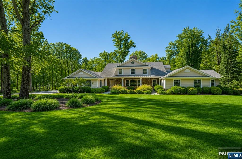 Nestled in Saddle River's prestigious Chestnut Ridge neighborhood, this exceptional 4-bedroom, 4.5-bath expanded ranch offers luxurious one-level living in a serene, private setting. Thoughtfully designed for both everyday comfort and elegant entertaining, the home features a bright, spacious chef's kitchen with a large center island, granite countertops, a walk-in pantry, and a sun-filled breakfast area. The beautifully landscaped, park-like backyard is a private oasis, complete with a heated in-ground pool, expansive patio, tranquil koi pond with a charming bridge, and plenty of space for outdoor gatherings or peaceful relaxation. The inviting interior also features a formal dining room with an adjoining butler's pantry, ideal for effortless entertaining. The luxurious primary suite serves as a private retreat, offering a spa-inspired bathroom with a spacious walk-in shower and heated floors. Additional highlights include an elevator for convenient access, a first-floor laundry room, and three fireplaces that create warmth and ambiance throughout the home. This rare offering combines timeless elegance, exceptional comfort, and resort-style outdoor living in one of Saddle River's most sought-after locations.