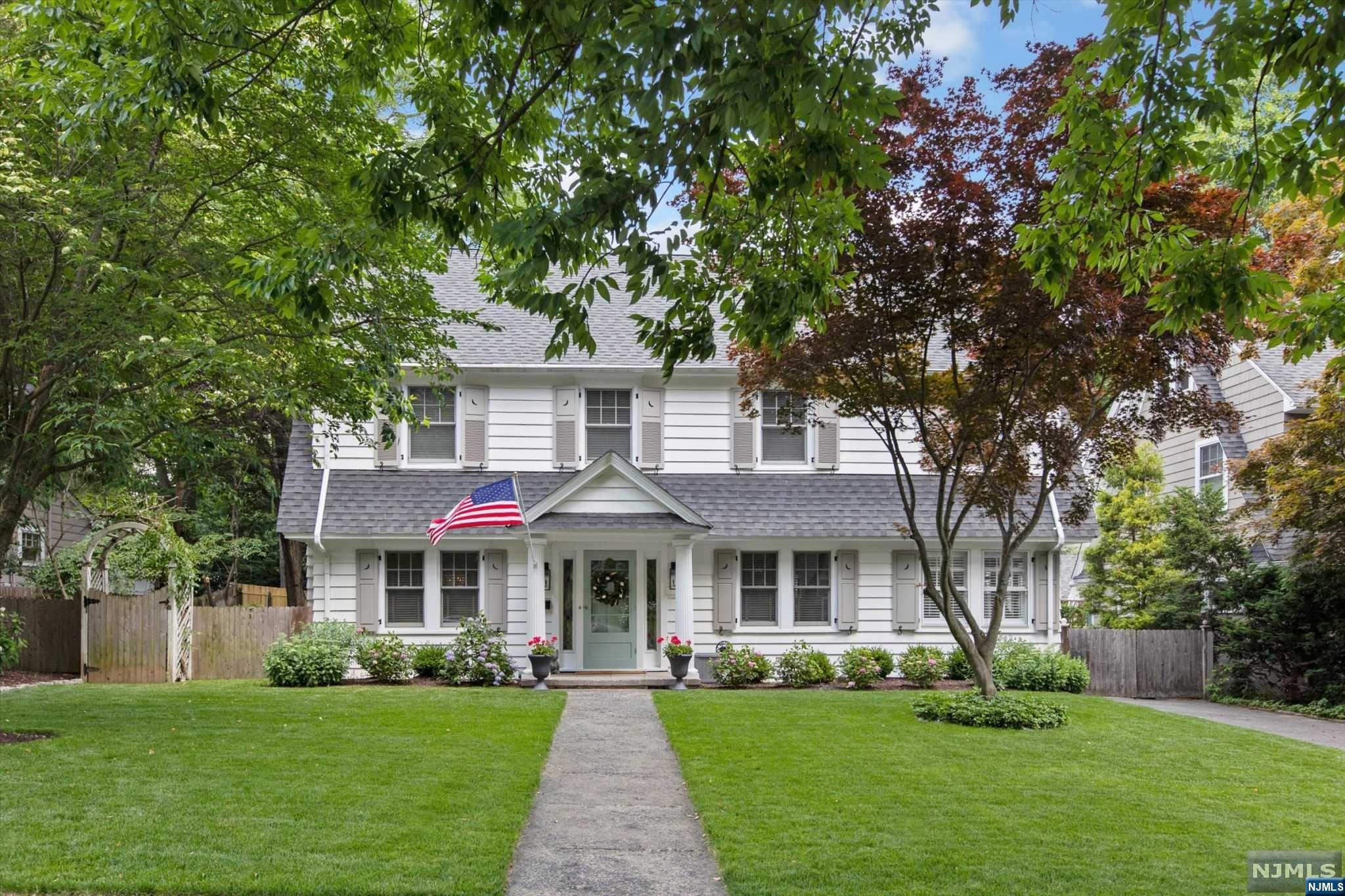 Exquisite and impeccably renovated, this elegant Center Hall Colonial perched on a beautiful tree-lined street is an Upper Montclair classic. Move-in ready and close to NYC transportation, schools, parks, sledding hills, and vibrant Upper Montclair Plaza. 5 BR and 3.5 BA with central AC and multiple work-from-home options. The renovated kitchen has high-end, Thermador appliances and a large kitchen island. The living room with a wood-burning fireplace flows into the sunroom, making it the ideal spot to relax and unwind. The second floor has 3 BR's and 2 full baths, including a spacious primary suite with walk-in closets, en-suite bathroom, soaking tub, and separate stall shower. The 3rd floor has 2 additional bedrooms with a full bathroom and extra storage. A private, fully fenced backyard is perfect for summer barbecues. The newly updated garage is air-conditioned and ready for your home gym. Grab an ice cream at nearby beloved Applegate Farms!