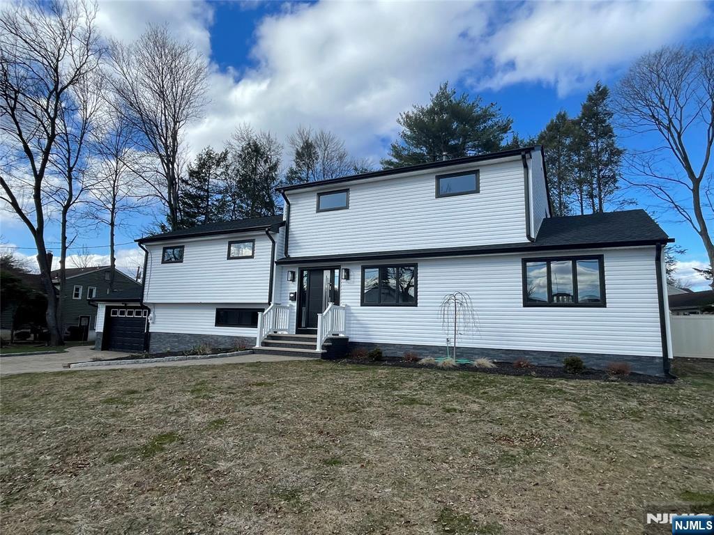 Updated Contemporary Split Level Home on large fenced-in park-like property. The Bright Entry hall of this home leads to the Living Room with hardwood floors, open to a new kitchen with stainless steel appliances and quartz countertops. The Dining Room is open to the Family Room with a new full bathroom. The 2nd level features a large Bedroom with along with new half bath. There are 2 more bedrooms and another new full bath. The 3rd floor has a Primary bedroom with Full bath. The lower level of this Contemporary home features another Family room and half Bath. All just a few feet away from the heated in-ground pool. New siding, new roof, and new deck. Large paver driveway. All this and low taxes! Close to all major malls and highways.