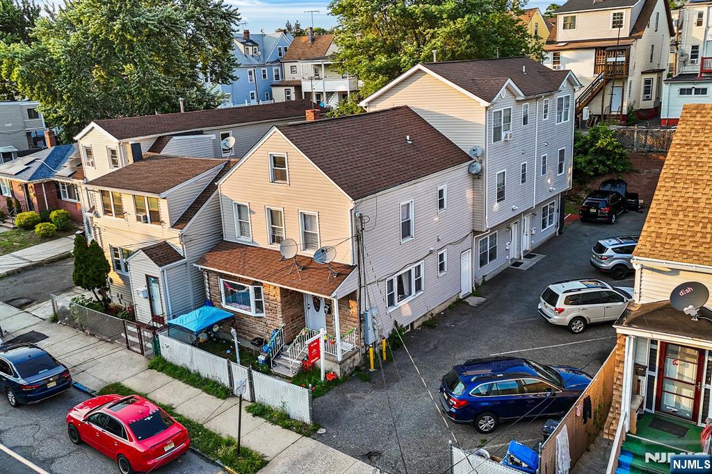 Welcome to this exceptional opportunity to own a rare 3-family property featuring three side-by-side duplex units, each offering the feel, privacy, and functionality of a single-family home in the heart of Paterson. This impressive property offers approximately 3,573 square feet of living space and features a total of 9 spacious bedrooms and 6 updated bathrooms. Each duplex spans three full levels and includes 3 bedrooms and 2 full bathrooms, providing generous living space ideal for Owner-occupants, investors. Each unit features hardwood floors throughout, in-unit washer and dryer, and separate living and entertaining areas designed for comfortable everyday living. The unique side-by-side duplex design provides a level of privacy and functionality rarely found in traditional multi-family properties. The property also features a private driveway with parking for up to 8 vehicles, making it ideal for both residents and guests. Conveniently located near shopping, dining, schools, major highways, and public transportation, this one-of-a-kind property offers exceptional flexibility and strong income-producing potential.