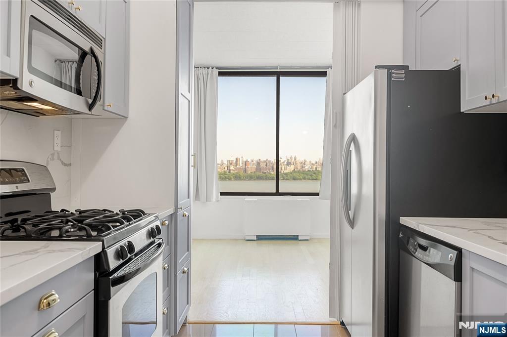 ALL UTILITIES, CABLE, HIGH-SPEED INTERNET, AND AMENITIES ARE INCLUDED IN THE HOA FEES. Rare oversized 1-bedroom + den residence with direct, unobstructed NYC skyline and panoramic Hudson River views, plus a private balcony and exclusive 9-foot ceilings. This east-facing home features a renovated kitchen and bathroom, hardwood floors throughout, generous closet space, a spacious living room, separate den ideal for a home office or guest space, and an oversized bedroom that easily fits king-sized furniture. Located in the highly desirable Park Hudson building, directly next to NYC transportation, with nearby NJ Transit bus routes and complimentary NY Waterway shuttle service offering an approximately 25â€“30 minute commute to Manhattan. Just moments from James J. Braddock North Hudson County Park and close to shops, restaurants, and everyday essentials. ACME Markets, Whole Foods Market, Trader Joe's, and Mitsuwa Marketplace are all about a five-minute drive away.