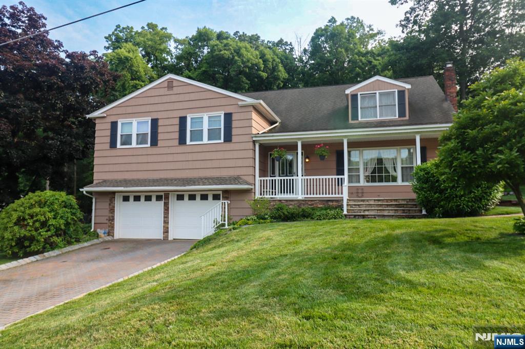 Exceptional oversized split-level home with two additions and four finished levels of living space! Updated kitchen (within the last 5 years) features granite countertops, soft-close cabinetry, glass display cabinets, built-in coffee bar, and Samsung black stainless appliances including French door refrigerator, double-oven range, and dishwasher. Kitchen opens to dining area and bright sunroom, creating a spacious, open floor plan. Large living room offers laminate flooring and a picture window for abundant natural light. Outdoor oasis includes a beautiful in-ground pool, multi-tiered deck, patio, two sheds, and paver driveway. home features two primary suites with private baths. Newer primary suite Boasts vaulted ceilings with skylights, Palladian window, private balcony overlooking pool, walk-in closet, bonus room accessed by private staircase (ideal office or sitting room), and luxury bath with soaking tub, walk-in shower, double vanity, and private water closet. Additional closet designed for future sauna. Ground-level family room showcases a stunning stone wall, wood-burning fireplace with stove insert, and accent lighting. Additional features include cedar shake siding, Timberline roof, two-car garage with 10-ft ceilings, extensive storage, and two garage door openers. A truly unique home offering exceptional space, flexibility, and indoor/outdoor living