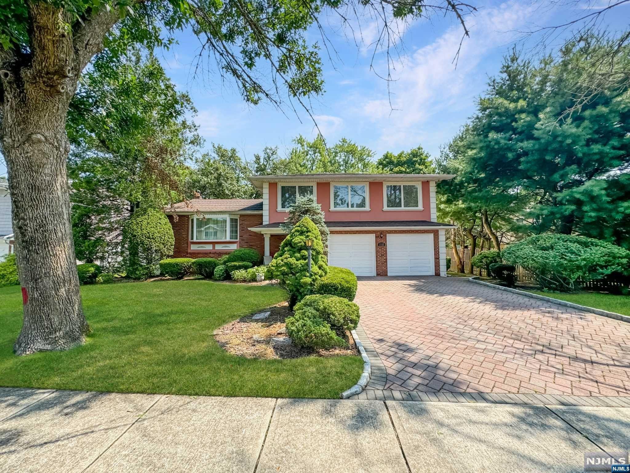 Welcome to this elegant and sophisticated sugar maple split, situated steps away from 2 Express buses to NYC and minutes to train station! This move-in ready home boasts gleaming hardwood floors throughout, a large primary suite with a private bath, and three additional generously sized bedrooms. Enjoy the inviting open floor plan with a modern, updated kitchen perfect for entertaining. The ground level offers a den with a half bath that leads through sliding doors to a charming patio in the private backyard, ideal for relaxation and gatherings. The finished basement provides additional living space to meet your needs. The 2-car garage and double-wide driveway ensure ample parking and storage. Conveniently located near shopping, highways, public transportation, parks, and schools! Seller is licensed Real Estate Agent.