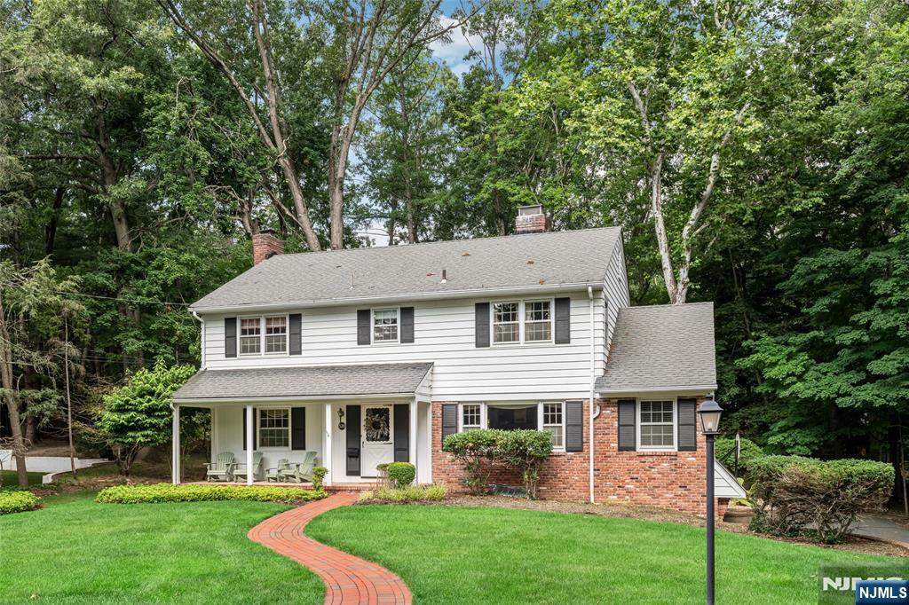Tucked at the end of a quiet cul-de-sac and surrounded by lush woods, this custom-built Roughgarden Colonial offers a rare country feel wrapped in suburban convenience. Step inside, and the craftsmanship is immediately felt. There are generous living areas, abundant windows, glistening hardwood floors, built-in cabinetry, and wood-burning fireplaces to set the tone throughout. The kitchen offers warm cabinetry, stone counters, and subway tile, with professional-style appliances, plus a dining area that overlooks the grounds. Four spacious bedrooms await upstairs, plus a flexible fifth-bedroom option on the main floor, ideal for guests or a home office. Throughout, there's room to add your own personal touches, and the basement offers the opportunity to create additional living space. Everyday life is made easier with first-floor laundry, an attached two-car garage, and bus service to all schools. It's a rare find: a warm, woodsy retreat that still keeps you close to everything. Come experience the quiet magic of 570 Bennington Road!