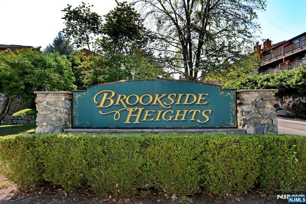Welcome to Brookside Heights! This 3 bedroom pet friendly complex is located close to parks, shopping & transportation. First floor entry hall, large eat-in-kitchen w/ss appliances, formal dining room, large living room w/wood burning fireplace & sliding doors to deck, 1/2 bath. The 2nd floor boasts a large primary bedroom w/full bath & sliders to deck, bedroom #2 w/deck, bedroom #3 and the main full bathroom in hallway. The lower level consists of an entry hall from the parking lot, entrance to 1 car attached garage, utilities, laundry and a den/playroom. Other features include, central air, attic storage, 1 included parking spot (#3i), plenty of visitor parking, pool & clubhouse. Water/sewer charge is $330 a quarter. A must see unit!