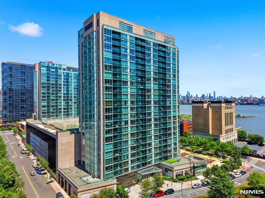 Luxurious 2-bedroom, 2-bath corner home with a den and private balcony showcasing beautiful NYC views, located in the sought-after community of 20 Newport Parkway. This residence has been completely renovated and has had only one owner. Enjoy a sleek, modern kitchen with new cabinetry and premium countertops, along with brand-new hardwood floors throughout. The spacious primary suite features a walk-in closet and an ensuite bath. A second bedroom, full second bath, and versatile den offer the perfect setup for a home office, guest space, or playroom. In-unit washer and dryer included. Full-service building amenities include 24/7 concierge, resident lounge, conference room, screening room, fitness center, jacuzzi, and a rooftop game room with breathtaking skyline views. Ideally located just minutes from the Newport PATH Station, Morton Williams supermarket, and Newport Mall.