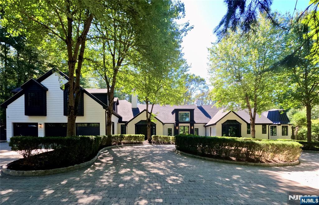 This exceptional, fully renovated and reimagined gated estate offers the perfect blend of modern luxury and timeless elegance. Situated on 1.5 private acres backing onto the prestigious Alpine Country Club golf course, this expansive residence (11,306 sq ft on first and second levels) has been completely transformed with premium materials and impeccable craftsmanship. The home impresses with a soaring ceiling in the entrance gallery, large grand reception rooms, state-of-the-art stunning gourmet chef's kitchen and a spectacular indoor swimming pool with radiant heated floors which seamlessly integrates into the home for year-round enjoyment (with a sauna, bath, and sleek built in bar and kitchenette). Additional highlights include a magnificent primary suite w/fireplace, terrace and two luxurious bathrooms. All oversized bedrooms each with their own bath, multiple living areas, and fully finished walk out lower level compliment the home. IMMEDIATE OCCUPANCY! Real estate taxes are $25,402!!!