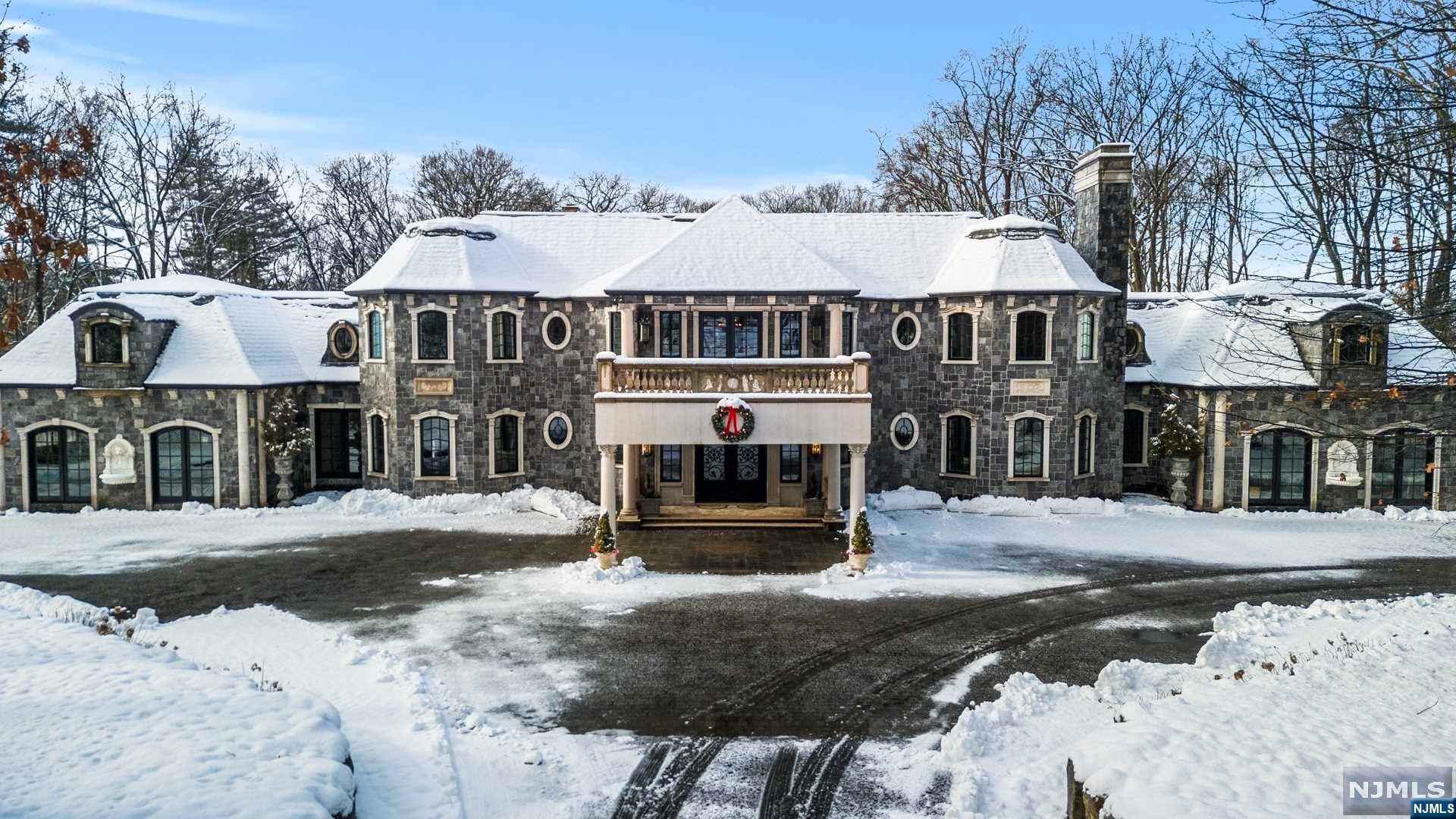 A majestic private driveway, adorned w/ trees leads to the iron gates of this timeless haven. Nestled on a pristine 4.5 acre estate, this remarkable residence boasts a generous living area spanning 15,426 sqft. Located just a short 20-min. drive from Manhattan, it offers unparalleled luxury & elegance for residents of all ages. Impeccably designed w/ exquisite finishes & tastefully decorated, it is truly a masterpiece. The magnificent Stone Mansion features 17 rms, including 5 bedrms, 7 full baths & 2 half baths. It also includes two 2 car garages, 4 fireplaces, & an indoor pool complete w/ a breathtaking 20 ft waterfall. There's a tennis court & spacious basement spanning 8,883 sqft. The property also offers approximately 3,000 sqft of terrace, patio & balcony space, perfect for enjoying the beautiful surroundings. Drastic price reduction! Seller shall consider all offers that are submitted by April 15, 2024. This is a sale by bid. Seller financing below market rate available.