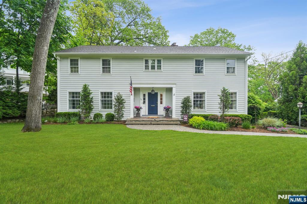 Experience the stately charm of this quintessential center hall colonial in Ridgewoodâ€™s sought-after Old Country Club section. Ideal for entertaining in either the elegant formal dining room or the handsome formal living room or relax by the fireplace in the cozy family room. A wonderful eat in kitchen, pantry/mudroom and powder room complete the first floor. Upstairs welcomes 4 generous bedrooms with pristine hardwood floors. The primary BR glows with warm sunlight and his/her closets and a double vanity full bath. The finished walk out basement is a recreational dream with an updated full bath. Donâ€™t miss the laundry room and storage area. This home is set on a private ½ acre with an expansive deck and fully fenced in level yard. Additional highlights include a 2-car garage, central vac, and a central alarm. Minutes to Orchard, GWMS, and RHS. A true gem for those seeking luxury and privacy in Ridgewood.