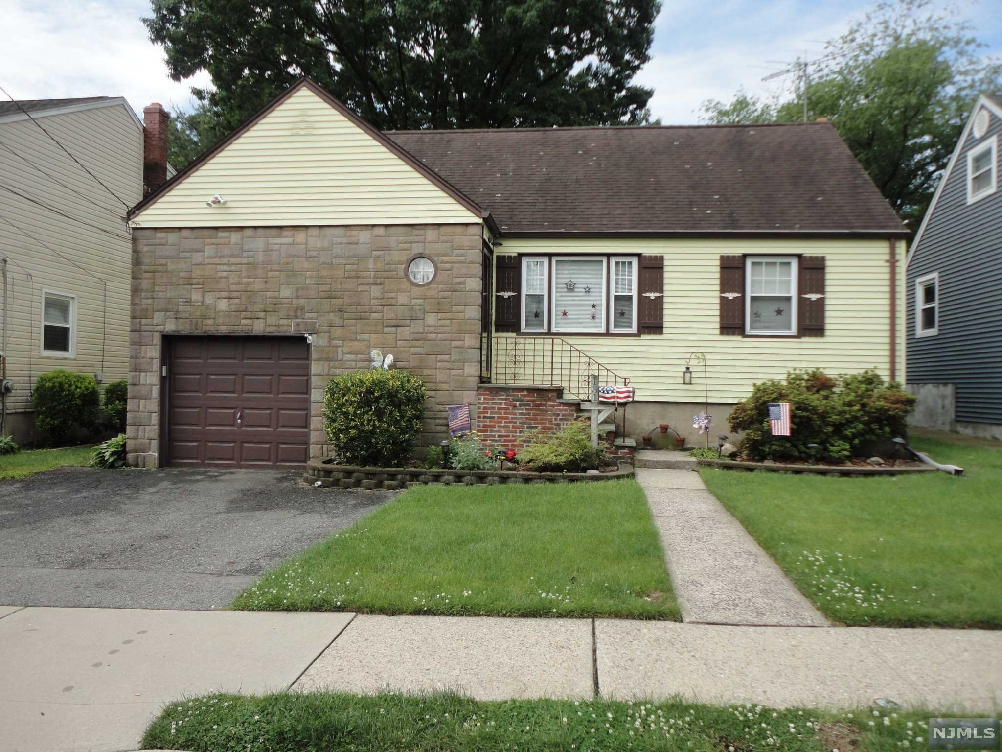 Feel the warmth of this lovely home the minute you enter! Walk into an entrance hallway with coat closet, inviting l/r boasts a brick accent wall and hardwood floors, updated eik features stainless steel appliances, spacious d/r w/ 8 ft sliding glass doors leading to lovely deck and beautifully landscaped yard. Four spacious bedrooms plus two full baths! Full finished basement w/access to one car garage. h/w floors throughout, c/a/c, great location, lots of curb appeal, priced to sell!!