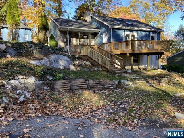 This Upper Greenwood lake home was completely renovated in 2022.The Great Room is wide open with a fireplace, wood beams,cathedral ceiling and skylights that bathe the living and dining areas in natural light. The kitchen has stainless appliances, soft-close cabinetry, quartz countertops, a mosaic backsplash and a work island with seating. There are glass doors off the great room that lead to an oversized deck. The master bedroom has a walk-in closet and private bath. There is also 2 more bedrooms and a main bath. The washer and dryer are located off the back entrance which leads to a patio and backyard. There is plenty of parking in the driveway and ample storage in the shed and lower basement level.Newer high efficiency appliances and systems are all electric for manageable utility bills. Lake rights, beach access plus boating is available. ( (Proof of Income, NTN Credit Report and Interview Required).