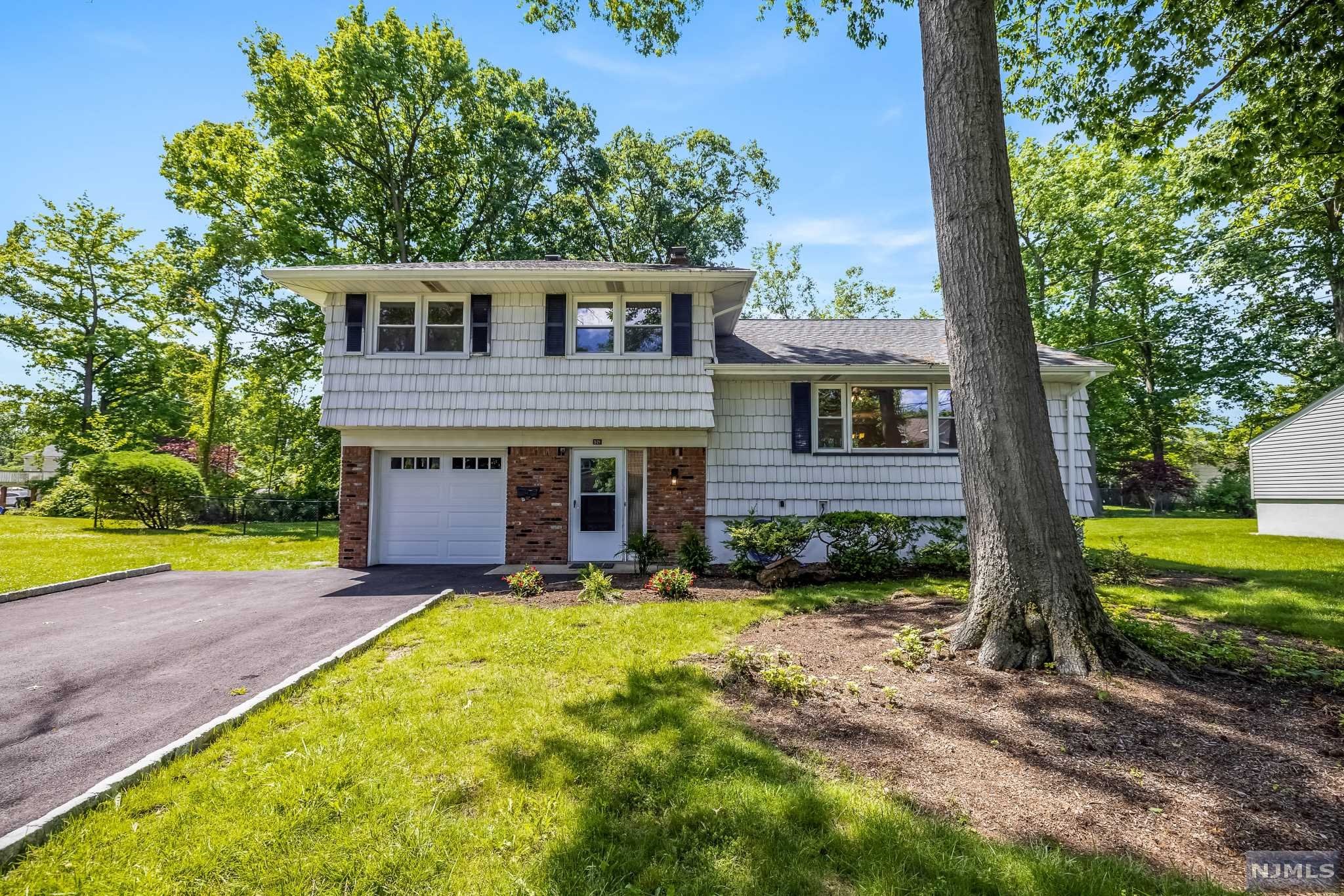 Updated and Move-In-Ready Sugar Maple Split with 3 bedrooms, 1 full bathroom, and 2 half bathrooms on a quiet and tree-lined street in the heart of Paramus. Large level lot with a HEATED IN-GROUND POOL! Spacious foyer greets you upon entry. Head up a few stairs to the large Living Room and Dining Room with beautiful hardwood floors. The Kitchen has been recently renovated with granite countertops, SS appliances, and white cabinetry. The Bedroom level hosts 3 nicely sized bedrooms, and 1.5 baths. (Primary features a 1/2 bath en-suite). On the ground floor find a family room and another 1/2 bath with laundry. Sliding Glass Doors to the large yard and pool! Single car attached garage plus unfinished basement with plenty of storage space. Can be finished in the future. Central Air & natural gas generator. Low Taxes, excellent schools, and easy commuting from this location.
