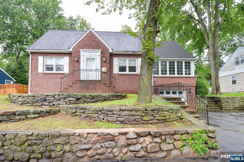 Charming custom-built brick cape in terrific location on tree-lined street!! Entry foyer, new kitchen opens to dining room, formal living room with fireplace, charming sun room, 1st floor bedroom, and new bath. Upstairs, two good-sized bedrooms and 2nd new bath. The basement is full of high ceilings and convenient entry to a one-car garage. Gas heat, central air conditioning, beautiful hardwood floors, brick and vinyl exterior, deck off kitchen leads to gorgeous private yard!