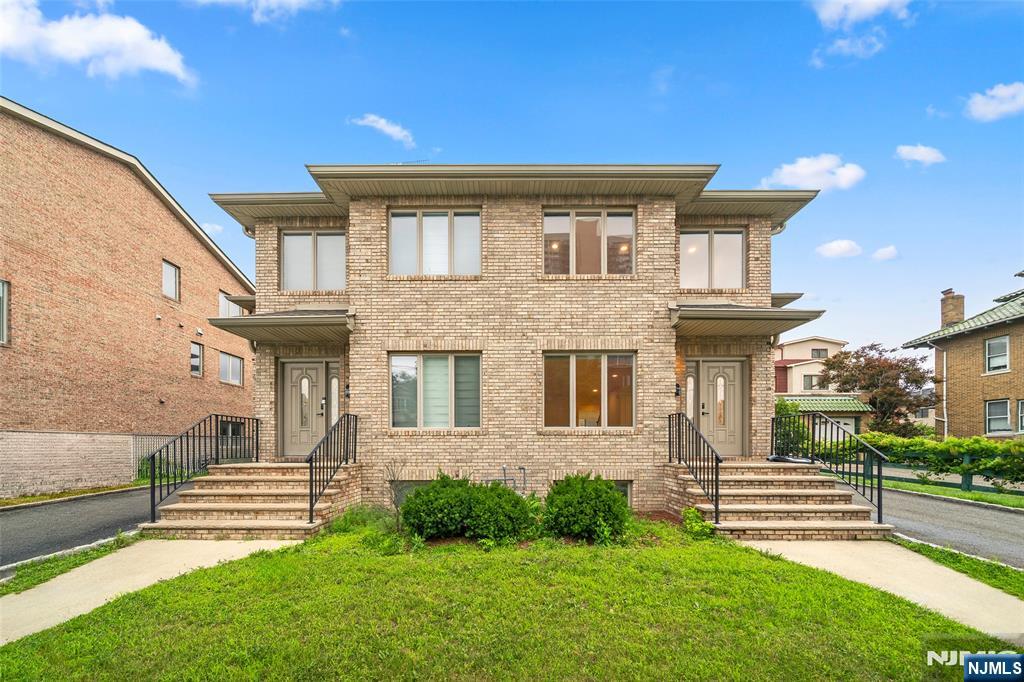 Welcome to this spacious 4-bedroom, 2 full bath, and 2 half bath home in a convenient Fort Lee location near Main Street. The main level offers a bright and open living area with hardwood floors, along with a beautifully renovated kitchen featuring modern cabinetry, quartz countertops, stainless steel appliances, a center island, and direct access to the backyard. Renovated bathrooms add a clean, contemporary touch throughout the home. The expansive finished ground level provides flexible space for a family room, recreation area, home office, or guest use, and also includes a half bath, laundry area, and separate entrance. Additional features include an attached garage, driveway parking, central air, and a private backyard. Conveniently located near shopping, dining, schools, parks, public transportation, and major highways.