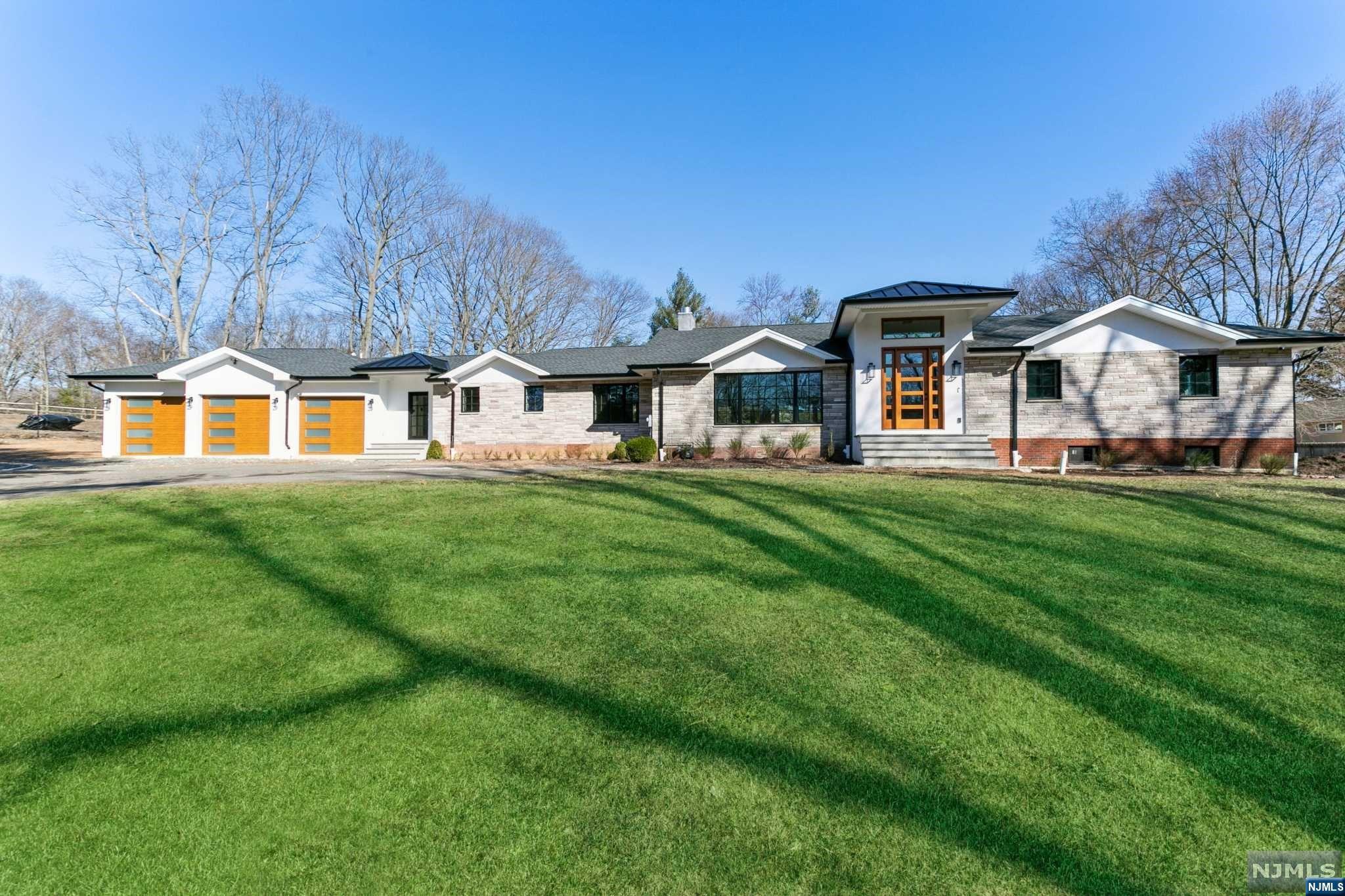 This stunning sprawling ranch home has 4,245 sq ft of living space plus 2,115 finished lower level (6,360) all on the original foundation. Entire 1st floor gutted with new addition. Step inside to the 2 story entry foyer with beautiful checkered marble flooring and be welcomed into the open concept floor plan. The kitchen offers quartz countertops, a custom walk-in pantry, a temp controlled wine refrigerator and beverage unit, cast iron farmers sink, and high end SS appliances. The living room features a dual fireplace and 3 sets of doors that lead out to covered Trex deck- perfect for indoor/outdoor living. There are 3 spacious ensuites, all with walk in closets and full baths. The primary bedroom comes complete with custom his & hers closets and luxurious, show-stopping wall to floor Spanish Porcelain with spa like shower & soaking tub. Pool is as is- equipment was removed for new addition. All new electric, walls, flooring, plumbing, roof- everything brand new!