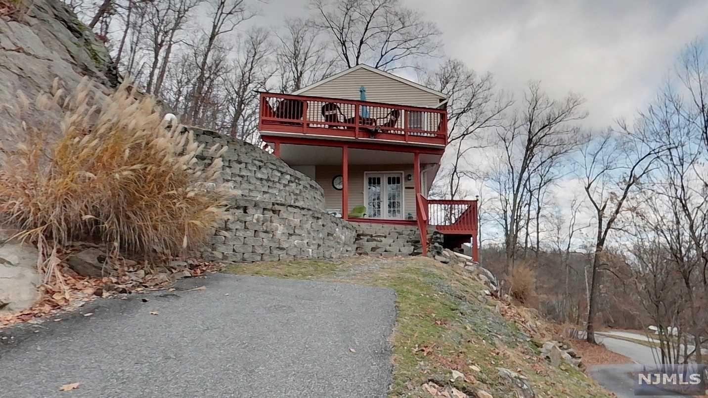 WELCOME TO 63 W SHORE DR. This is a potential AirBnB Opportunity or the move in ready home you have been searching for. Located in a very desired area of Vernon Township, close to Warwick, NY. Just minutes from get aways at Crystal Springs Resort, Ski Resorts, Spas, Zip-lining, Hiking and Mountain Bike Trails, Farms and more. This naturally lit Colonial home was built in 2003. With over 3 acres of land facing Pleasant Valley Lake, enjoy the lake scenery in the winter and in the summer enjoy this private home. Sit back & relax in the wrap around deck which starts on the first floor and wraps up to the second floor overlooking the lake. The first floor features a family room & master bedroom with full bath. Master bedroom has French doors which leads to the front porch. On the second floor we have 2 spacious bedrooms with a full Jack & Jill Bath, Laundry room, Kitchen with a breakfast bar and living/dinning room combo. Living/Dining Room features a cathedral ceiling. Inquire today!