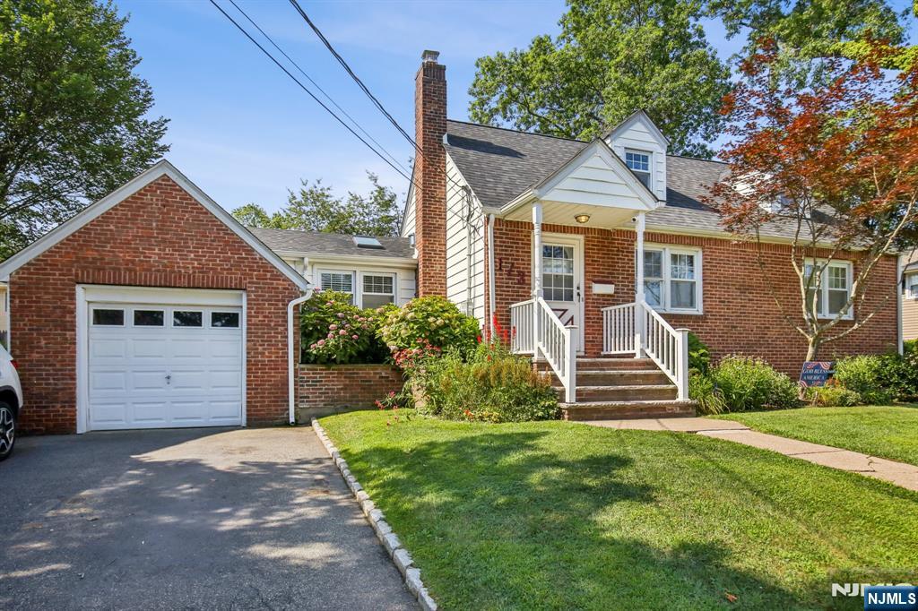 Welcome to this beautifully updated sun filled home offering space, light, and flexibility. The main level features a bright living room, dining area, updated kitchen with breakfast nook, and a spacious family room that opens to the deck and fenced backyard. The first floor primary bedroom with nearby full bath makes single level living easy. Upstairs, two large bedrooms with generous closets share a modern full bath. The lower level provides incredible bonus space with a summer kitchen, full bath, office, and family room ideal for extended living or entertaining. New floors, fresh paint, and modernized baths highlight some of the updates. Enjoy outdoor living on the deck overlooking the private yard with storage shed. Centrally located near schools, parks, shops, and NYC transportation, this move in ready home combines comfort and convenience in a sought after neighborhood.