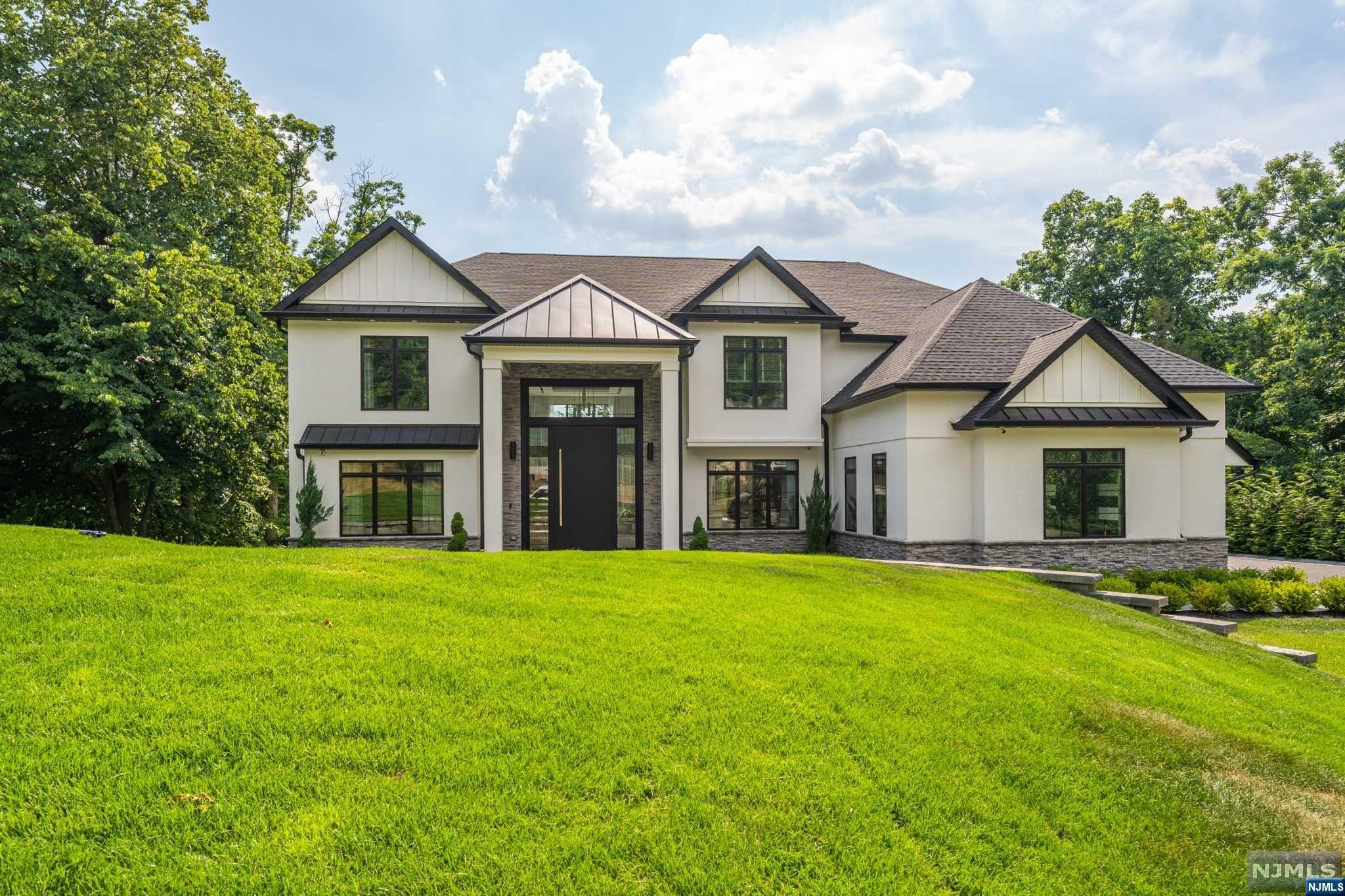 Situated within the prestigious Hills section, this exquisite colonial, built in 2020, offers a sense of seclusion while being local to shopping, dining, schools, and amenities. The grand two-story foyer welcomes you into a luxurious, naturally lit living space that flows seamlessly from the living room to the dining room and into a chef's dream kitchen that boasts custom cabinetry, a center island, and top-of-the-line appliances, including a Wolf stove top and dishwasher, and a Sub-Zero fridge, microwave, and double oven. A cozy family room complete with an electric fireplace, a half bathroom, and a home office round off this level. Ascend stairs to discover a lavish primary suite with an en suite bathroom, a walk-in closet, and a private balcony to soak in breathtaking views. A princess suite with its own bathroom, two additional bedrooms, a common bathroom, and a convenient laundry room equipped with a washer and dryer make this level perfect for everyday living.