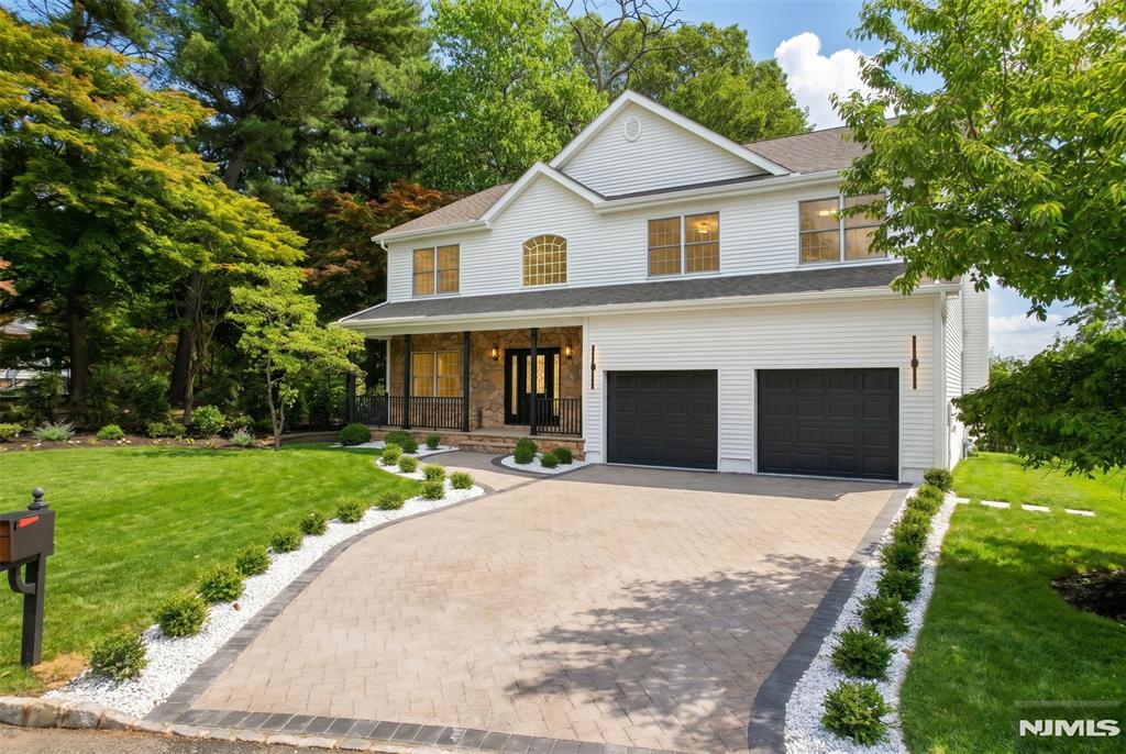 Nestled on a quiet dead-end street in one of Westwoodâ€™s most desirable neighborhoods, this beautifully maintained Center Hall Colonial offers over 3,000 square feet of living space and the perfect combination of luxury, comfort, and convenience. Enjoy picturesque views from the kitchen and expansive rear deck overlooking a lovely natural vista. The first floor features a welcoming living room with a fireplace, formal dining room, updated eat-in kitchen, laundry room, powder room, private office/den, and direct access to the attached two-car garage. The second floor boasts a spacious primary suite complete with a luxurious bath and dressing room, along with four additional bedrooms and two full bathrooms. The fully finished basement provides exceptional additional living space and includes a half bath, making it ideal for recreation, a home gym, media room, or guest overflow. This home showcases true pride of ownership and has been extensively updated, including the kitchen, bathrooms, laundry room, appliances, cooling system, lighting, flooring, and many other improvements throughout. Hardwood floors, spacious rooms, and a thoughtful floor plan make this home both elegant and functional. Tucked away from busy streets yet conveniently located near downtown Westwood, top-rated schools, parks, shopping, dining, and NYC transportation, this move-in-ready home offers a rare opportunity to enjoy peaceful suburban living in a highly sought-after location.