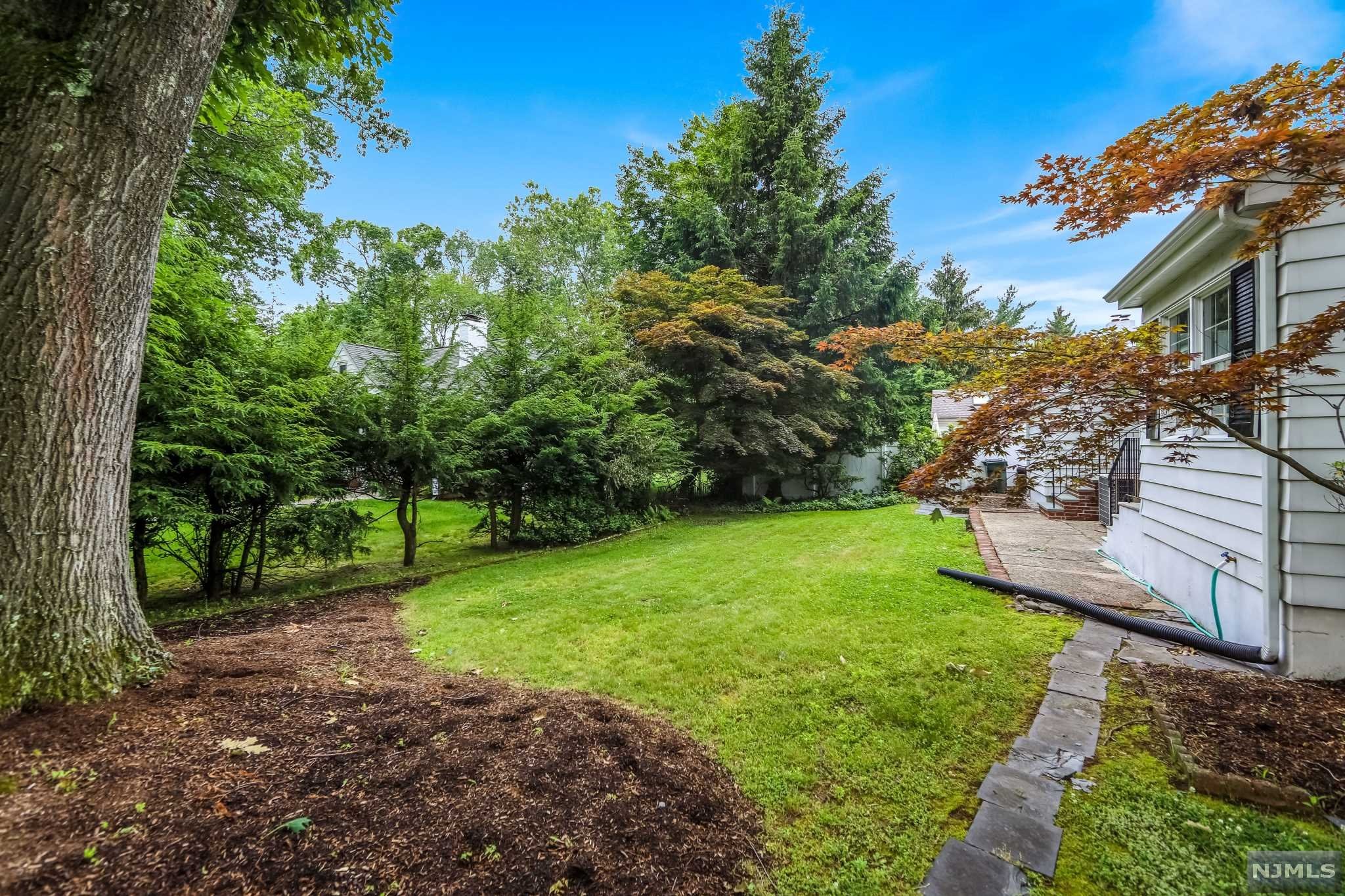Don't miss this amazing property! Welcome to this 3-bedroom Cape Cod home that is filled with natural light and features an updated kitchen with granite countertops, an inviting sunroom, and hardwood floors. The yard is located on the corner of Garden, a tree-lined quiet street, yet close to public transportation, shopping, restaurants, and everything Dumont has to offer! Highlights include a new roof, new hot water heater, updated kitchen, central air, patio, and large private yard, great for summertime fun and barbecues. Call Lana today to Snap it up before it's Sold!