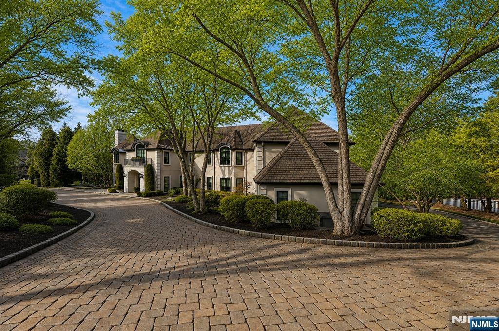 Perched high atop sought-after Tammy Brook Hills, this exceptional residence offers breathtaking views and refined luxury at every turn. A dramatic two-story foyer sets the tone, introducing a home defined by sophisticated design and meticulous attention to detail. The main level features expansive entertaining rooms alongside a sun-filled family room that opens seamlessly to a gourmet kitchen, ideal for both everyday living and hosting. The primary suite is a true retreat, highlighted by a spa-inspired bath, dual designer dressing rooms, and picturesque Ramapo Mountain views. Three additional en-suite bedrooms and two bedrooms sharing a well-appointed bath complete the upper level. The walk-out lower level is thoughtfully designed for versatility and enjoyment, offering a bedroom with bath, gym, spa bath with sauna, bar, arts and crafts room, childrenâ€™s learning center, and private office, all with direct access to the backyard and pool. Additional amenities include a full-house generator, radiant heat, and two laundry rooms. A rare offering that must be experienced to be appreciated.