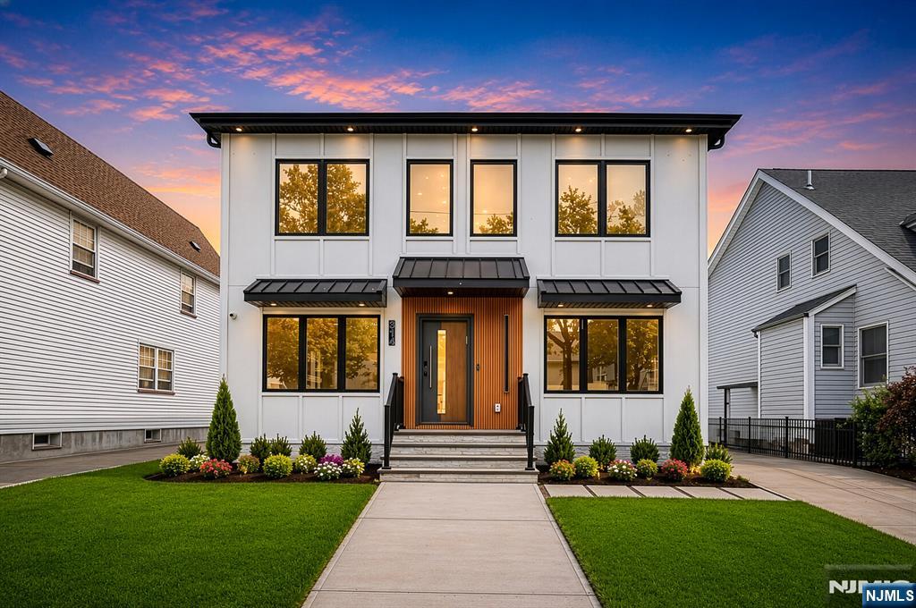 Luxury, functionality, and timeless design come together in this stunning new construction in the heart of Rutherford. Designed with both everyday living and entertaining in mind, this home features an open-concept layout, a chef-inspired kitchen with sleek European cabinetry, a custom walk-in pantry, and seamless access to a spacious deck overlooking a fully fenced backyard. A rare first-floor bedroom and full bath offer flexibility for guests, extended family, or a private office. Upstairs, you'll find four additional bedrooms, including a luxurious primary suite complete with a private balcony, spa-like bath, and dual walk-in closets. Two junior suites provide the perfect blend of comfort and privacy. The fully finished basement expands your living space with a large recreation room and powder room, while premium upgrades including Pella windows, EV charging, and surround sound elevate the home's modern appeal. All of this just moments from Rutherford's renowned restaurants, charming downtown, and convenient NYC transportation.