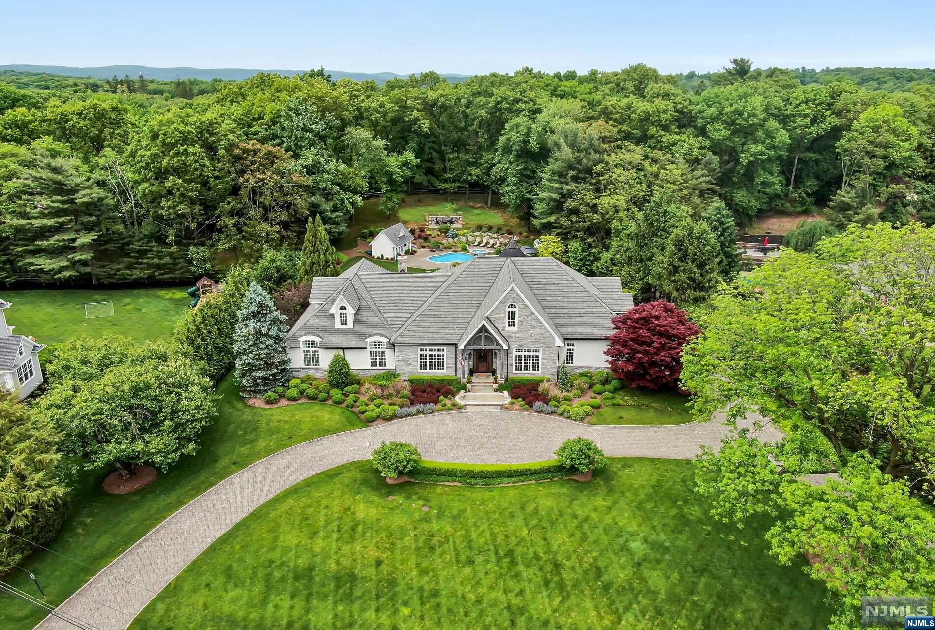 Something amazing happens when high quality construction and design are in harmony. It hits the perfect balance. Suddenly, the spaces inside have attitude...a voice. As you enter this exceptional estate, breathtaking architectural details blend to perfection with an open concept flow and modern-day spaces, fixtures, and detail. Find a huge light filled great room opening to a designer kitchen with 2 huge islands and hi-end appliances. Over the last 2 years, this house has undergone a complete $1.1MM renovation. Does it have a voice? ABSOLUTELY! Renovations created a unique bonus flex space, adaptable rooms, a spectacular Lower Level speak easy lounge/pub(with wet bar)/music room plus media, gym, full bth. There is so much more...a LUXE Primary Suite (with a WOW! WIC that must be seen), 2 addt'l bedrms and office on the main level. NEW 2000 sf 2nd floor guest suite w/2 bedrms, fam rm, kitchenette, and spa bath! Sitting on 1.5 pristine acres with a glimmering gunite