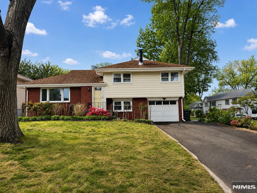 Well maintained split-level home on a corner lot in a residential neighborhood. Features entrance foyer, bright living room, open dining area with access to large deck, and modern eat-in kitchen with granite countertops and stainless steel appliances. Second floor offers full bath, two bedrooms, and primary bedroom. Ground level includes den with fireplace (as-is), full bath, and attached one-car garage. Partially finished basement with recreation room, laundry area, and storage space. Enjoy fenced backyard with large deck perfect for entertaining and outdoor gatherings. Attached one-car garage completes this home.