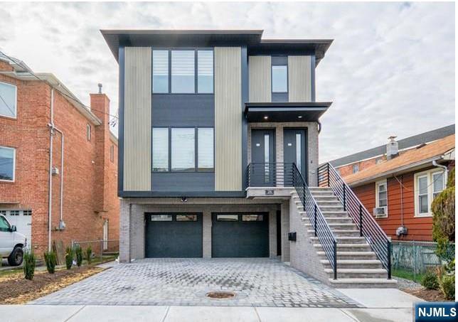 Experience modern luxury in this stunning, 2-year-young two-family home. Situated on an exceptionally quiet street, the extra-deep lot provides a lush, expansive backyard perfect for outdoor entertaining. The top-and-bottom layout features massive living rooms and oversized bedrooms flooded with natural light. Each main unit boasts a gourmet kitchen with a center island, quartz countertops, custom cabinetry, and top-of-the-line appliances, complemented by beautifully designed, spa-like bathrooms. The finished basement adds incredible value, featuring two additional bedrooms, a secondary kitchen, and a dedicated washer/dryer area. Fully occupied and meticulously finished, this property is a rare find where scale meets sophisticated design.