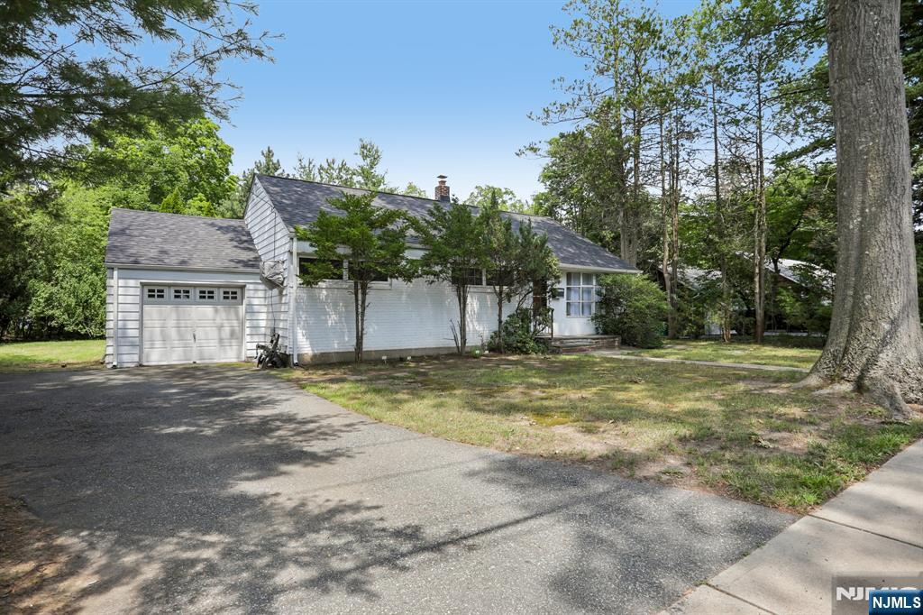 Set on a tree-lined property in Ho-Ho-Kus, this three bedroom, one bath home offers a functional single level layout and an excellent opportunity to update and make it your own. The main level features a spacious living room with exposed wood beams and large bay window, an adjoining dining room, an eat-in kitchen, and a bright enclosed porch/family room overlooking the property. Three bedrooms and a full bath complete the first floor. The full unfinished basement includes laundry, abundant storage space, and a separate bonus room offering additional possibilities. An attached one-car garage and mature landscaping complete the property. A solid home with great potential for buyers looking to renovate, expand, or create a space tailored to their needs.