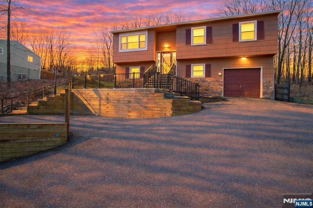 Opportunity in White Meadow Lake. This 4 bedroom, 2.5 bath bilevel offers a chance to create real value in one of the area's most desirable lake communities. Priced at $499,900, well below recent neighborhood averages, this is a smart buy for anyone looking to build equity. The home features hardwood floors throughout the upper level, a spacious layout, and a primary bedroom with its own private bath. Additional highlights include central air, a deck overlooking a wooded backdrop, and a 1-car garage. Major systems have already been addressed, including a newer boiler in 2012 and AC in 2011 providing a solid foundation for your updates. With some cosmetic improvements to the kitchen, baths, and finishes, the upside here is clear. Enjoy all that White Meadow Lake has to offer, including three beaches, two pools, tennis and pickle ball courts, and year-round recreational amenities like fishing and boating, all within close proximity to major highways, shopping, and parks. A rare chance to buy into the neighborhood at this price point and make it your own.