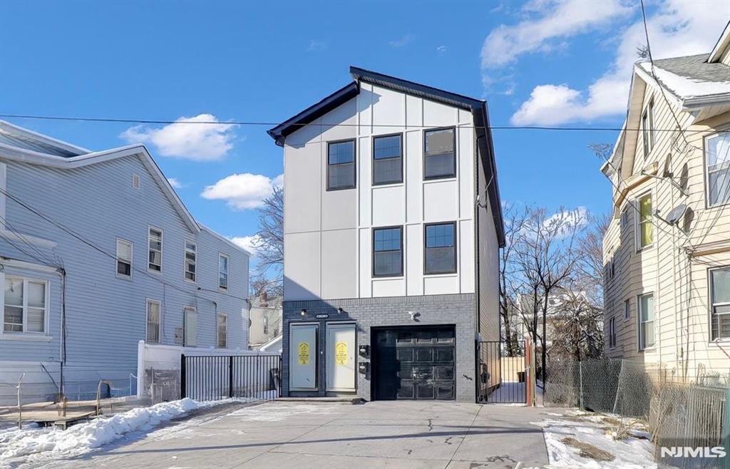 Explore the epitome of modern living in Irvington. This custom new-construction two-family residence offers a thoughtfully designed layout with quality finishes throughout. Each apartment features a functional floor plan with bright, open-concept kitchens equipped with ultra-stainless steel appliances, quartz countertops, and rich custom cabinetry. The first unit extends to the ground level, creating an exceptional duplex with flexible living space ideal for recreation, a home office, or additional living area. This level includes a bathroom, laundry, and direct access to the garage. Both the first and second floor apartments offer three spacious bedrooms and two full bathrooms. Primary bedrooms include walk-in closets and contemporary en-suite bathrooms with modern fixtures and a spa-like feel. Additional highlights include a gated patio, yard, and driveway, a one-car garage, and a driveway accommodating up to six additional vehicles. Enjoy low taxes with a 5-year tax abatement. Conveniently located near parks, shopping, dining, and NYC transportation, this home offers easy access for commuting and everyday living.