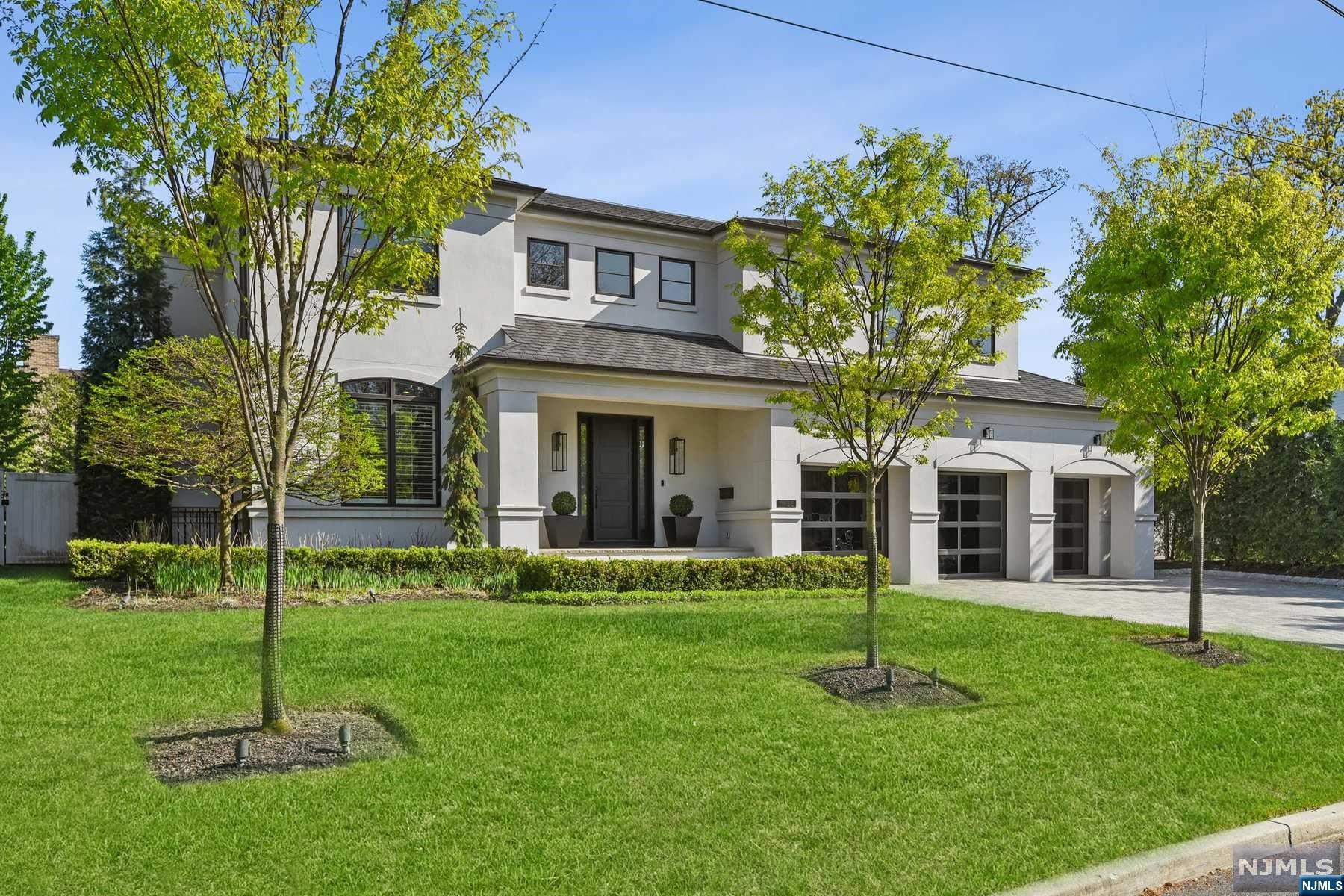 Welcome to this builder's home located on the upper North side of Englewood Cliffs - a rare blend of luxury and modern elegance. This stunning home offers an open floor plan with a designer-decorated interior that caters to the needs of today's discerning buyer. The main level features an open great room, dining room and gourmet kitchen. It also includes a living room/office, guest bedroom suite, laundry room, mudroom, and a heated 3-car garage. The second level boasts a luxurious primary suite, three additional bedroom suites, and a second laundry room. The lower level is a perfect place to relax and unwind with a wet bar, open recreation area and an additional bedroom and bath. The rear yard is a private oasis featuring a covered porch, built-in grill, and large in-ground spa. Additional amenities include radiant heat, Sonos music, custom built-ins, a full-house generator, motorized shades, and more. This incredible home offers the perfect blend of luxury and comfort.