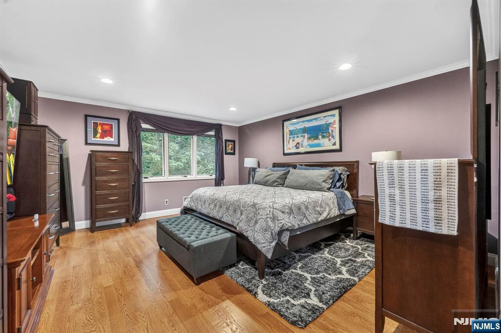 Set within the Peach Hill community, this 3-bedroom, 3.5-bath townhouse offers over 3,000 square feet with a multi-level layout that gives the home both character and charm. Hardwood floors, oversized windows, and spacious living areas create a welcoming feel throughout, while the open-concept kitchen features rich wood cabinetry, granite countertops, stainless steel appliances, skylight and center island seating that naturally brings everyone together. The separate sitting room adds another inviting space to relax, entertain, or unwind at the end of the day. Large living room with door to the deck and beautiful green space. The primary suite feels peaceful and tucked away with large windows overlooking greenery, a walk-in closet, and an updated bath with dual sinks, jacuzzi tub, Stall Shower and modern finishes. Additional bedrooms offer comfortable space for family, guests, or work-from-home flexibility. The lower level expands the home even further with a large recreation room, additional guest bedroom and full bath, office space and tons of storage. Complete with a large attached 2 car garage. Conveniently located just minutes from downtown Ramsey, the Main Street train station, restaurants, parks, golf, and shopping.