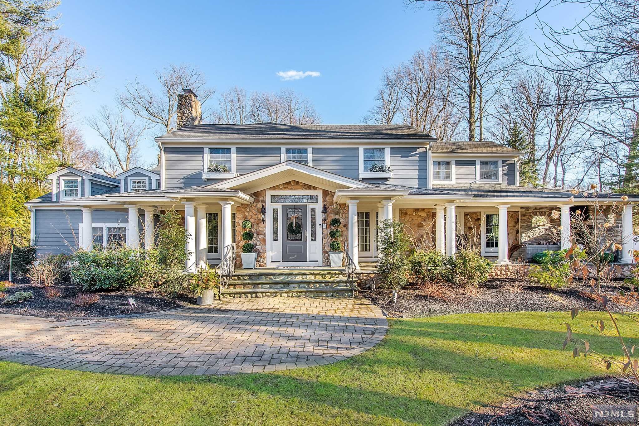Exceptional Essex Fells Colonial offers the ultimate lifestyle and exclusivity. Extraordinary architecture with jaw-dropping modern industrial interior design. Design-savvy enthusiasts will be in awe of this exquisitely designed property incorporating the perfect blend of farm house coupled with raw elements, dramatic lighting and sleek metals. Desirable floor plan created to meet the needs of today's lifestyle, seamlessly incorporating private spaces along with areas to come together for enjoyment. First floor has a custom mudroom, high-end kitchen, family room, living room, industrial bar room and office. Office offers a library, cozy stately fireplace and access to the wrap around porch. Chef's Kitchen is a showstopper with massive island, custom cabinets, limestone countertops, top of the line appliances and stone fireplace. The second level encompasses five bedrooms, including a well appointed, exquisite master bedroom suite. Sprawling backyard with a patio and yard space.