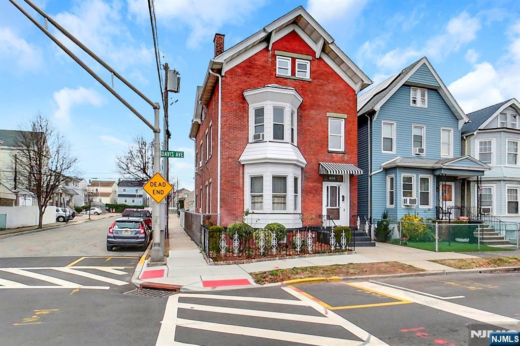 Welcome to 400 Davis Ave, a well-maintained all-brick 3-fam in vibrant Harrison, NJ. This versatile building boasts 3 spacious aparts, an excellent opportunity for both homeowners & investors alike. The 1st fl features 2 generous beds, large kit, living w/ fireplace & dining room. Dining room can adapt as 3rd bed. Upper units, each: 2 beds, a sizable kitchen, & living area. Thoughtful layout ensures abundant natural light, creating a welcoming & comfortable space. The finished basement, ideal for entertaining or casual gatherings. Seamless flow from basement to yard enhances outdoor living experience, perfect for hosting family & friends. Convenience is, 2-car garage & driveway. Located in the heart of Harrison, easy access to nearby amenities, transportation, & community resources. Whether you are looking for rental income or wanting to start your journey in homeownership, this property is ideal for you. We invite you to schedule a viewing, experience its charm & potential firsthand!