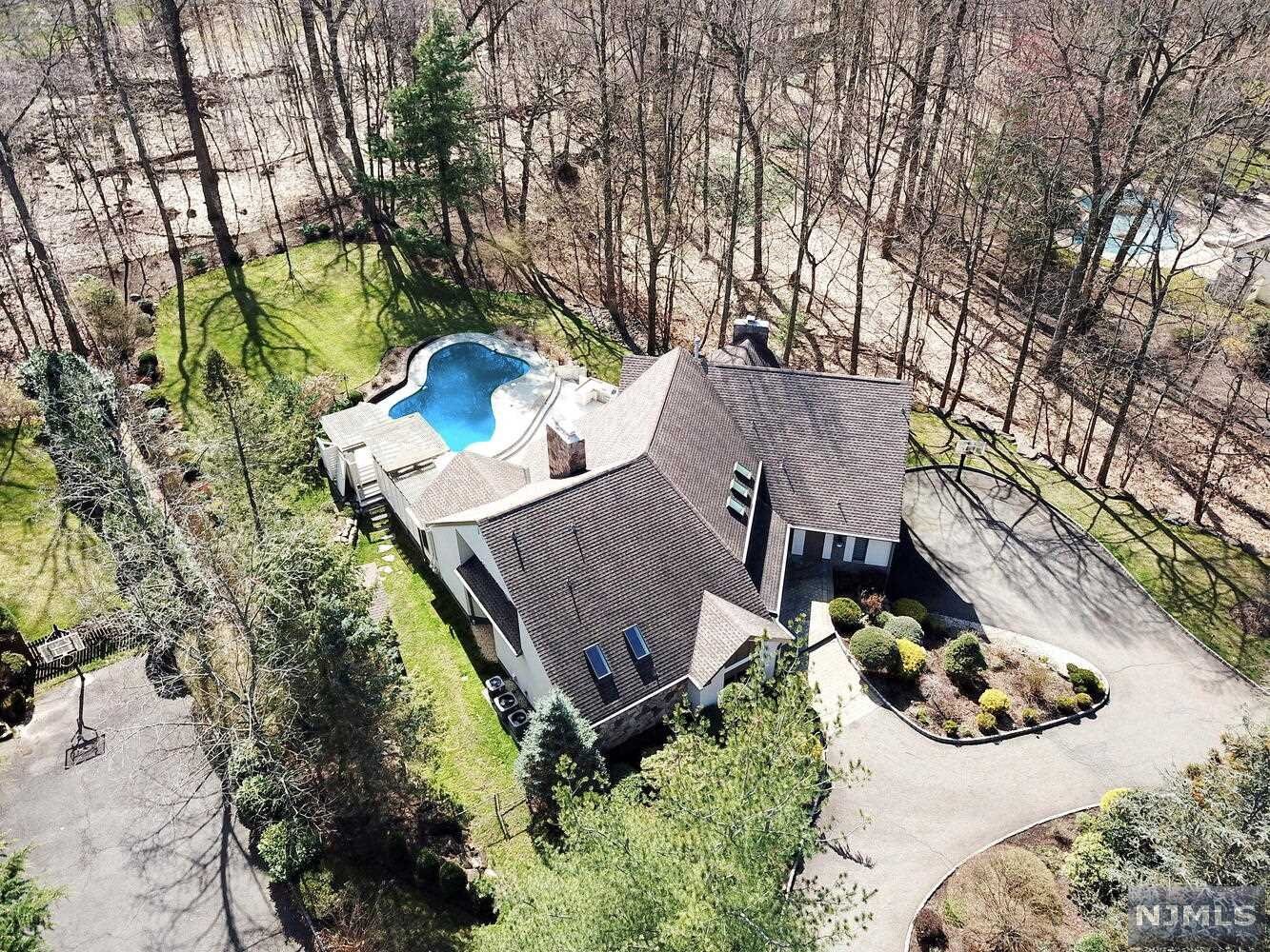 A GREAT OPPORTUNITY TO LIVE IN RIO VISTA SECTION OF CRESSKILL, WONDERFUL CONTEMPORARY HOME BEAUTIFULLY SET ON 1.17 ACRES WITH GORGEOUS BACKYARD. THIS HOME FEATURES A BRIGHT ENTRANCE FOYER, SPACIOUS LIVING RM WITH FLOOR TO CEILING WINDOWS OVERLOKING THE INCREDIBLE BACKYARD, FIREPLACE, AND VAULTED CEILING, FAMILY RM WITH FIREPLACE, VAULTED CEILING, AND SLIDER TO A DECK, FORMAL DINNING RM AS WELL AS A GOURMET KIT WITH BREAKFAST AREA, 1ST FLOOR MASTER SUITE INCLUDING SLIDING GLASS DOOR TO BACK DECK, FIREPLACE, LUXURIOUS BATHROOM W/SOAKING TUB & DOUBLE VANITY, 2ND FLOOR INCLUDING EN SUITE BR, TWO ADDITIONAL BRS, TOTALLY UPGRADED FULL BATH, AND LOFT AREA, THE LOWER LEVEL IS PERFECT FOR ENTERTAINING WITH RECREATION AREA, OFFICE OR BR, DEN, AND STORAGE AREA,3 CAR GARAGES WITH CUSTOMIZED CABINETS, THE PRIVATE BACKYARD WITH LARGE DECK WITH IN GROUND POOL, JETTED TUB AND OUTDOOR KITCHEN, RADIANT HEATING FLOOR ON FAMILY RM AND MASTER BR, GAS POWERD BACKUP GENERATOR, 4 YRS OLD SIDING.