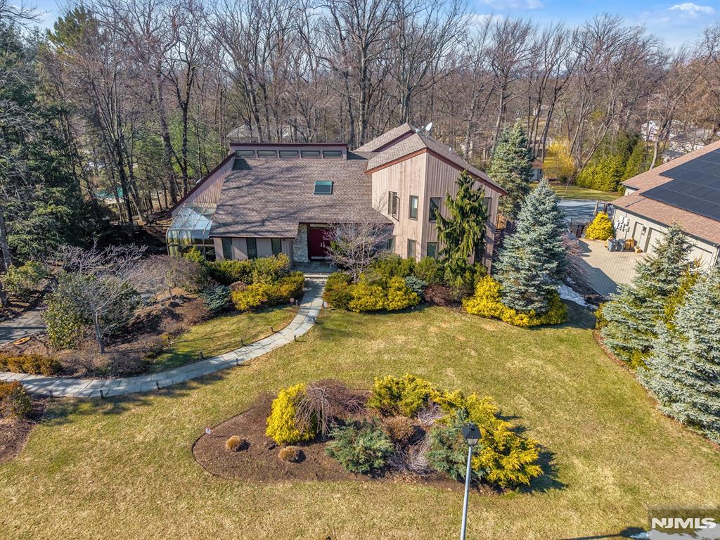Dramatic, bright, and beautifully renovated contemporary home set on one of North Caldwellâ€™s most sought-after streets. This modern 5 bedroom, 3.5 bathroom residence offers a light-filled, open and airy layout with soaring ceilings, skylights, and expansive windows throughout. The spacious great room features a striking stone fireplace and seamless access to the expansive two-tier deck, ideal for indoor/outdoor entertaining. The newly renovated kitchen with huge center island, SS appliances, and quartz countertops is complemented by a stunning glass-enclosed atrium, creating a truly unique and sun-drenched space enjoyed year-round. The main level features a generous primary suite with dressing area, 2 walk-in closets, and a spa-like bath with jacuzzi tub and stall shower, along with another bedroom and convenient first-floor laundry. Upstairs offers three additional bedrooms. The amazing and fully finished basement includes a large recreation space plus bonus sauna room! Set on a beautifully landscaped large property with mature plantings, the private backyard offers multiple outdoor living areas and exceptional tranquility. Complete with a 2-car garage and long driveway. Located in ultra-desirable North Caldwell, close to top-rated schools, shopping, dining, and parks.
