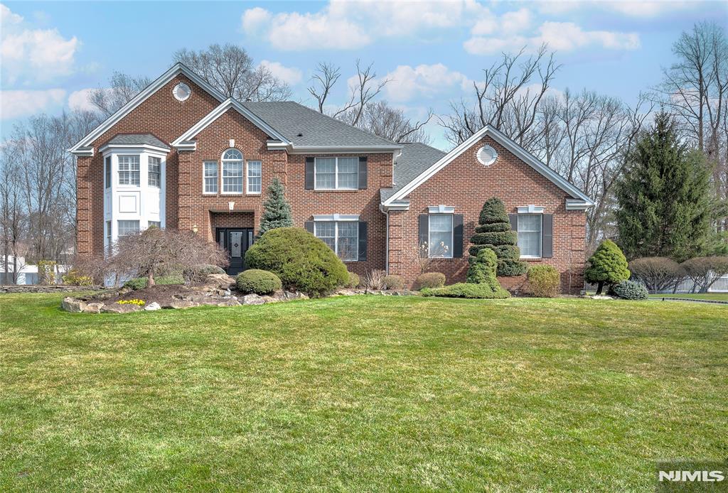 Nestled on a cul de sac, this stately and beautifully maintained colonial perched on meticulously manicured grounds is not to be missed. The dramatic 2 story entry (gorgeous walls are painted not wallpaper) welcomes you into this 5 bedroom, 3 full bath home perfect for entertaining. Brand new hardwood floors on first floor (Feb 2026), eat in kitchen with island and granite countertops, formal dining room, living room, and family room with fireplace. A bedroom/den, full bath and laundry room completes the first floor. Primary bedroom with high ceiling, updated bath (3 yrs) and walk in closet with door to additional storage. Large finished basement spans width of the house and offers plenty of storage. . **BRAND NEW ROOF AND GUTTERS just installed on 3/29/2026 with lifetime guarantee. This beauty is located close to school, parks, shopping, town pool.