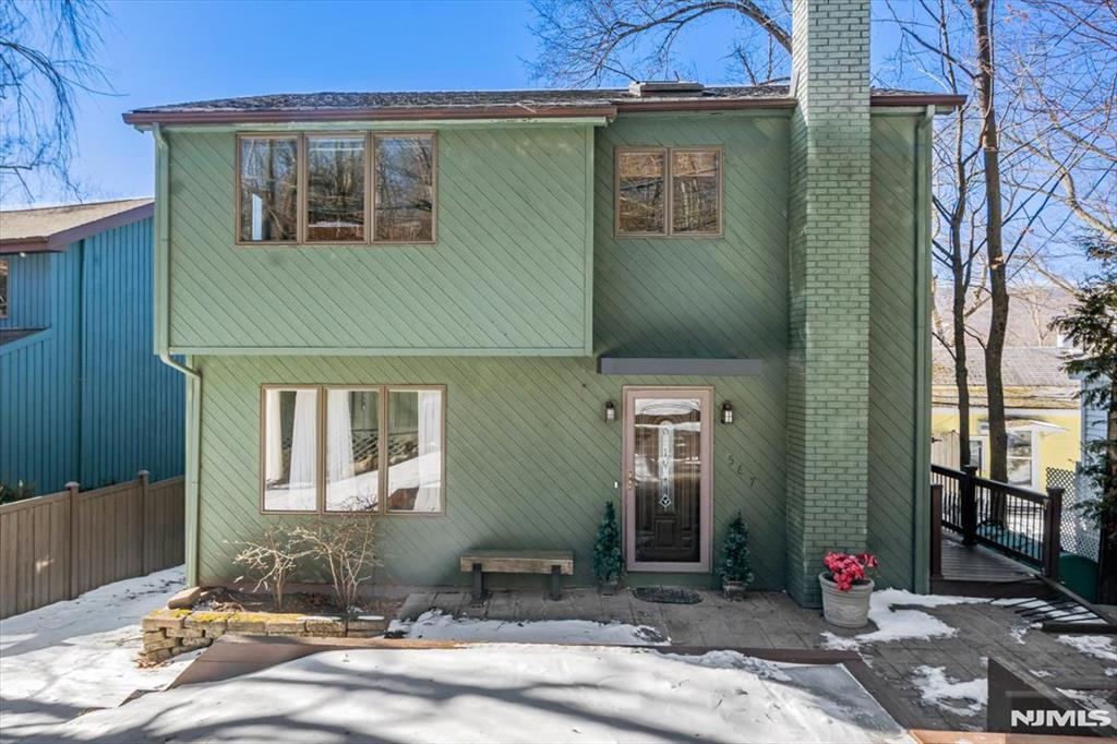 Welcome to this stunning lakefront home on Greenwood Lake, offering breathtaking views and tranquility. Situated on one of the best waterfront lots, this contemporary gem blends luxury and serenity. Featuring 3 bedrooms, 2.5 bathrooms, and gorgeous hardwood floors, the home boasts a chef-inspired kitchen with a center island, built-in cabinets, and high-end stainless steel appliances. The living room offers a cozy wood-burning fireplace and skylights. The spacious primary bedroom provides direct access to a well-appointed bathroom with double sinks and a relaxing tub. Two additional bedrooms offer comfort and versatility, with one featuring a skylight for an airy touch. A walkout finished basement adds extra space. Enjoy a private dock on the 7-mile lake, perfect for boating, swimming, and fishing. Conveniently located near wineries, ski resorts, and orchards, this home offers the ultimate lakefront lifestyle!
