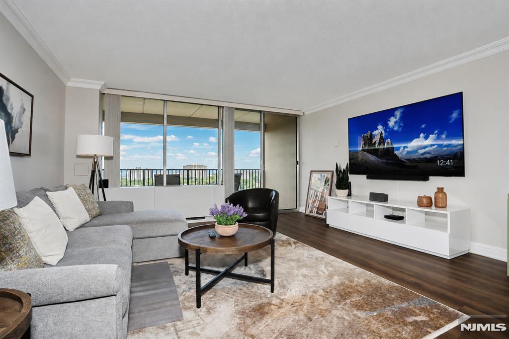 CONTACT DEBRA JACOBS (201) 803-3191 & HALLEY NATKIN (917) 626-8240 COLDWELL BANKER FORT LEE...DIRECT FOR MORE INFORMATION AND A PRIVATE TOUR! GORGEOUS FULLY FURNISHED TURNKEY HOME!. Just Bring Your Toothbrush. This one's done. Top to bottom, fresh, and offered completely furnished (new furnishings from Haverty's & Crate and Barrel!) so the only thing between you and move in day is the elevator ride up. High floor at Horizon House Fort Lee. Approximately 1,062 sq. ft. of bright, open living with floor-to-ceiling windows and two private balconies that catch the kind of sunsets people stop and stare at. Inside: a large renovated kitchen, crown and baseboard molding throughout, an updated full bath, and a walk-in closet that actually fits everything. And yes, a coveted indoor parking spot (#182) transfers with the unit. One monthly fee of $2,244.17 covers everything. Utilities, taxes, amenities, the garage spot all of it. No surprise bills, no nickel-and-diming. (Maint. $965.11; util/tax/mtg $681.9; garage $105.60; cap assessment $400; cable $71.54; amenities $20. A portion of maintenance is tax deductible.) All of it sits on 32 landscaped acres in the heart of Fort Lee: doorman, 24-hour security, fitness center, community room, two pools, two tennis courts, play areas, and an on-site convenience store. The GWB and the skyline are right there. Board approval required. 4:1 income-to-debt ratio; all-cash purchases require a minimum gross income of $107K.