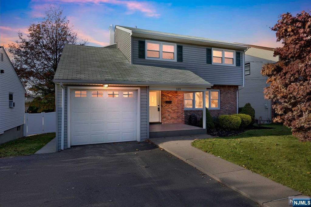 Welcome to this beautiful renovated colonial home in the heart of Woodridge. This home has central air & forced heat, an attached one car garage, hardwood floors throughout and more. The first floor features a living room, dining room, kitchen with quartz countertops, soft close cabinets, stainless steel appliances, & more, 1/2 bathroom. There is a ground level family room that can be used as a playroom or office, with entrance to the garage. Upstairs has a big primary bedroom with a beautiful modern primary bathroom. There are 3 more good size bedrooms and a bathroom upstairs. Fully finished basement & fenced in backyard! Come check this great home with new roof being installed as well!