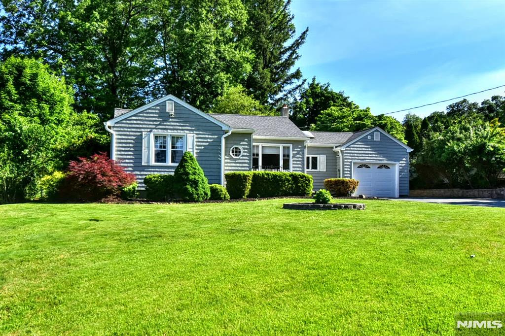 Welcome to this inviting 2-bedroom, 1.5-bath ranch offering outstanding curb appeal in one of the area's most sought-after neighborhoods, known for its schools and strong surrounding home values. Set on a beautifully landscaped property with mature, colorful plantings and a welcoming presence, this home offers comfort today and exciting possibilities for the future. The main level features hardwood floors throughout, a comfortable living room, dining room, kitchen, two bedrooms, a full bathroom, convenient half bath, laundry area, and ample closet space, all thoughtfully laid out for easy everyday living. An attached 1-car garage provides added convenience and storage. Downstairs, the partially finished, carpeted basement offers valuable additional living space and includes a built-in bar, making it ideal for an entertaining space, recreation room, family room, home office, or workout area. A dedicated workshop area adds even more flexibility for hobbies or creative pursuits. Outside, the backyard and deck offer wonderful opportunities for outdoor enjoyment, whether hosting gatherings, gardening, playing, or simply relaxing in a private setting. Whether you're looking for a move-in-ready home, a downsizing opportunity, or a property with room to grow, this ranch presents exceptional expansion potential. Combining comfort, functionality, and a prime location surrounded by well-maintained homes, this property offers a wonderful opportunity to make it your own.