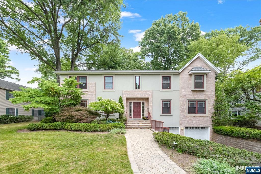 41 Downey Drive offers exceptional space, comfort, and versatility on a beautiful quiet street in one of Tenafly's most desirable neighborhoods. Thoughtfully designed for both everyday living and entertaining, the home features a modern kitchen, bright and inviting living spaces, a spacious family room, and an elegant dining room that's perfect for holiday gatherings and special occasions. The second level offers four generously sized bedrooms, including a luxurious primary suite with two spacious walk-in closets. The finished lower level provides outstanding flexibility, featuring a home office or fifth bedroom, a full bathroom, and a large recreation and lounge area. Outside, mature landscaping and beautiful outdoor living spaces create a private, park-like setting that's ideal for entertaining, relaxing, and enjoying time with family and friends. Ideally located in the heart of Tenafly, this home is just a short walk to top-rated schools, houses of worship, parks, and public transportation to New York City. Combining timeless appeal, generous living space, and an exceptional location, 41 Downey Drive offers a truly outstanding lifestyle.