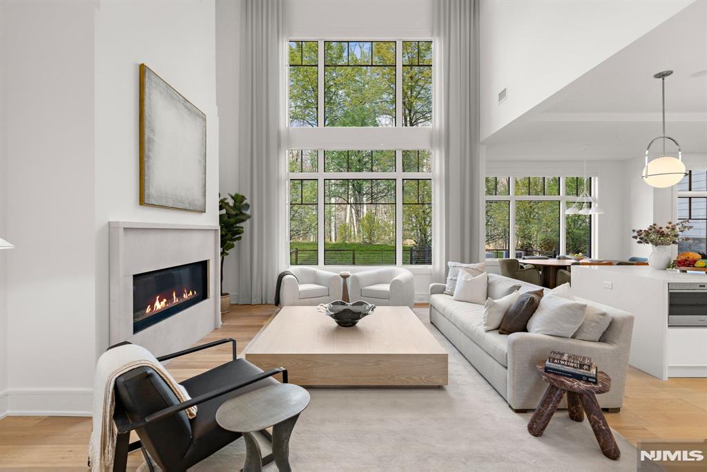 This exclusive, gated enclave of 24 newly constructed townhomes is perfectly appointed with a resident clubhouse, fitness center and private pool. Situated amidst 15 serene wooded acres with breathtaking views of the esteemed Alpine Country Club, 1 Stone Bridge Court is a 'Cambridge' floor plan featuring 4 bedrooms, 4.5 baths and 2 car garage and driveway. Designer Kuche+Cucina kitchen with SubZero & Wolf appliance package, modern spa baths, 10'+ ceilings throughout, whole home generator, air filtration system, smart home technology and much more. Conveniently located minutes from Manhattan, shopping, entertainment and transportation. Developed in collaboration with Zampolin & Associates Architects and Rock Ridge Construction. At The Woodlands, luxury living and natural beauty come together in an unparalleled setting designed for those seeking the finest lifestyle.