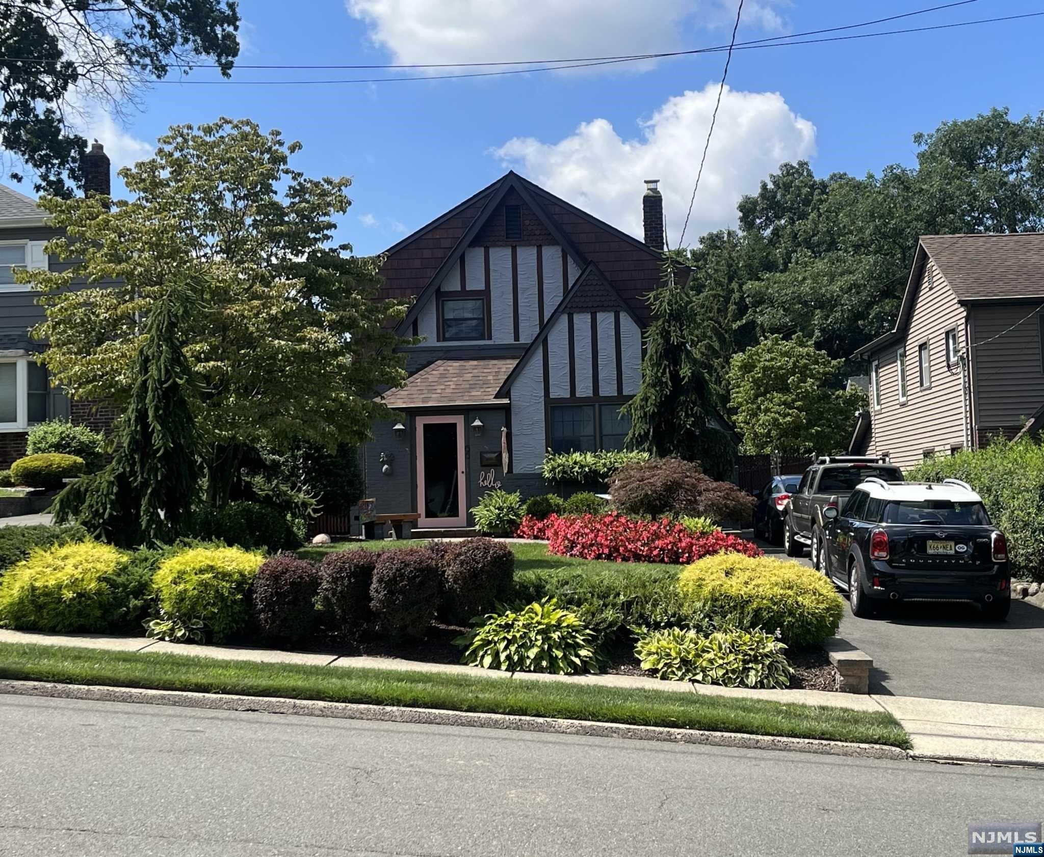 Tastefully renovated Tudor style colonial on one of the nicest streets in Wood-Ridge. The 1st floor features an entry foyer with closet, modern kitchen with breakfast nook, formal living room and dining room with tropical views from all windows. The 2nd floor has two bedrooms and one full bath. There is a large attic. Finished basement with family room and laundry room. Escape to your beautifully maintained private oasis with an in-ground cement pool surrounded by lush landscaping, a covered patio with ceiling fans, decorative lighting and tv set up. Sprinkler system. Fabulous for entertaining. Plenty of driveway parking. New roof, newer furnace, hot water heater, electric and windows. 3 Duckless AC/Heat units. Custom built shed/workshop. Low Taxes! NJ & NYC mass transit is just down the block. There are also two train stations in Wood-Ridge.